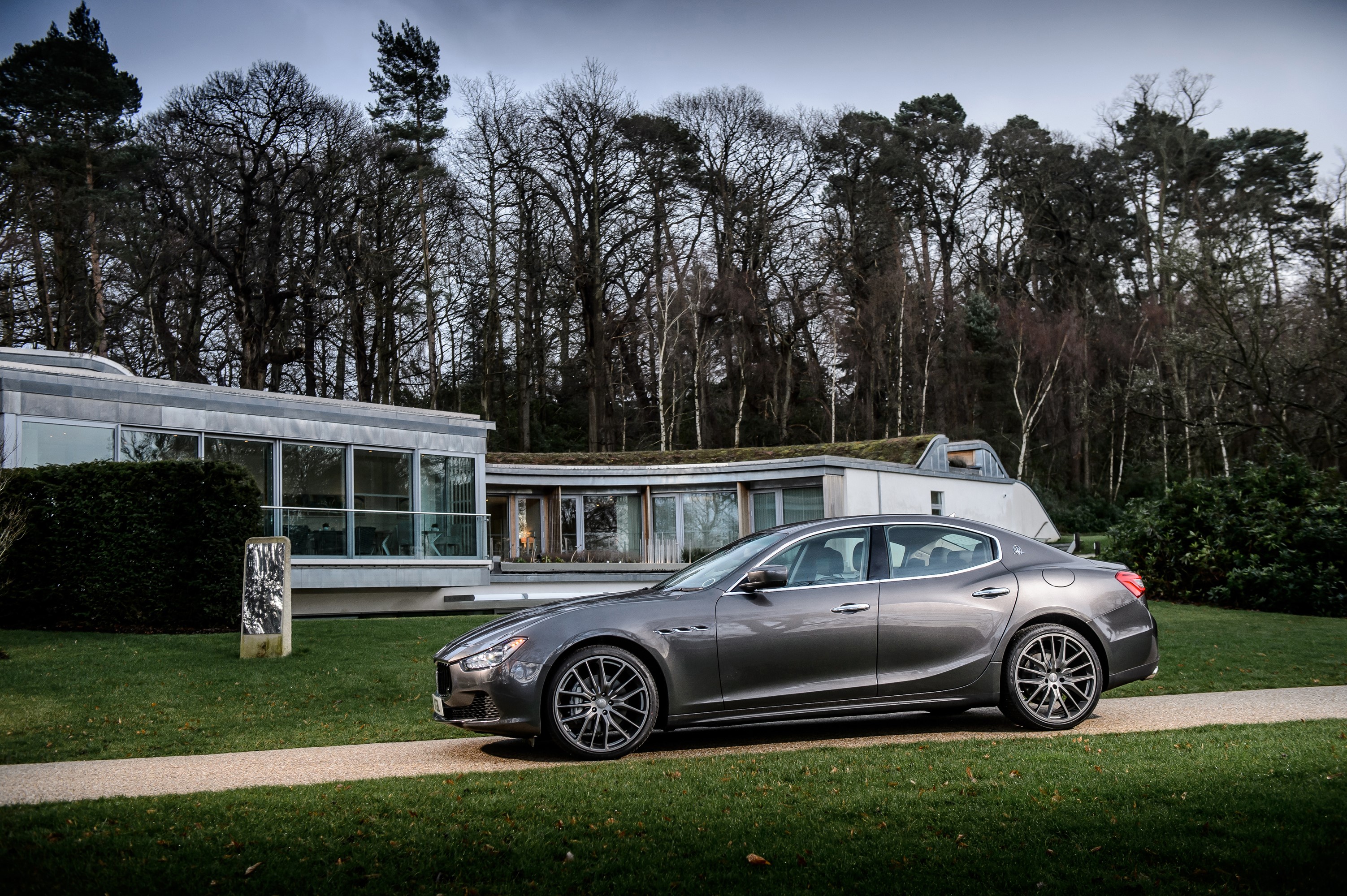 Maserati Ghibli parked in front of a modern house HD Wallpaper