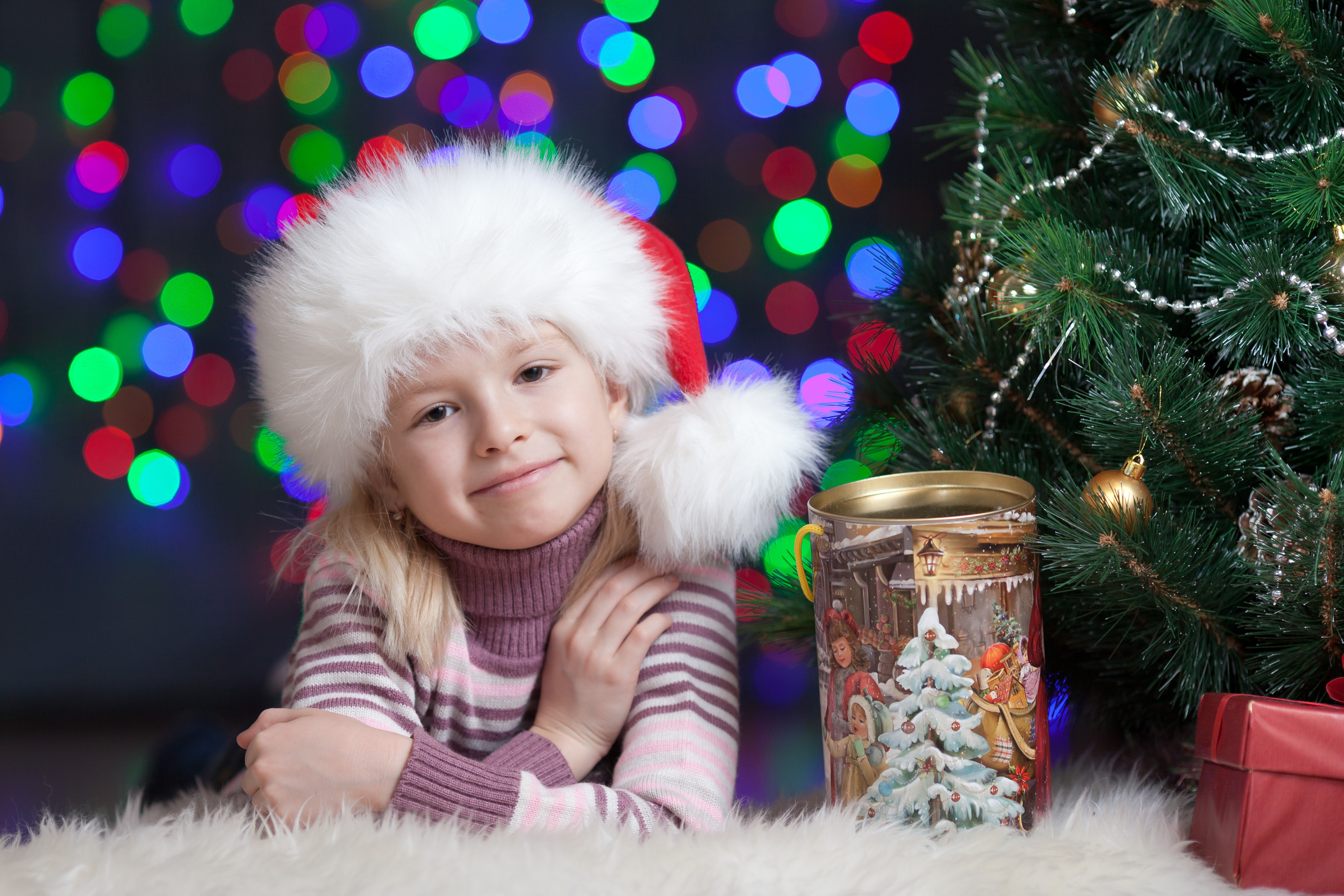 Girl in Santa hat by Christmas tree HD Wallpaper