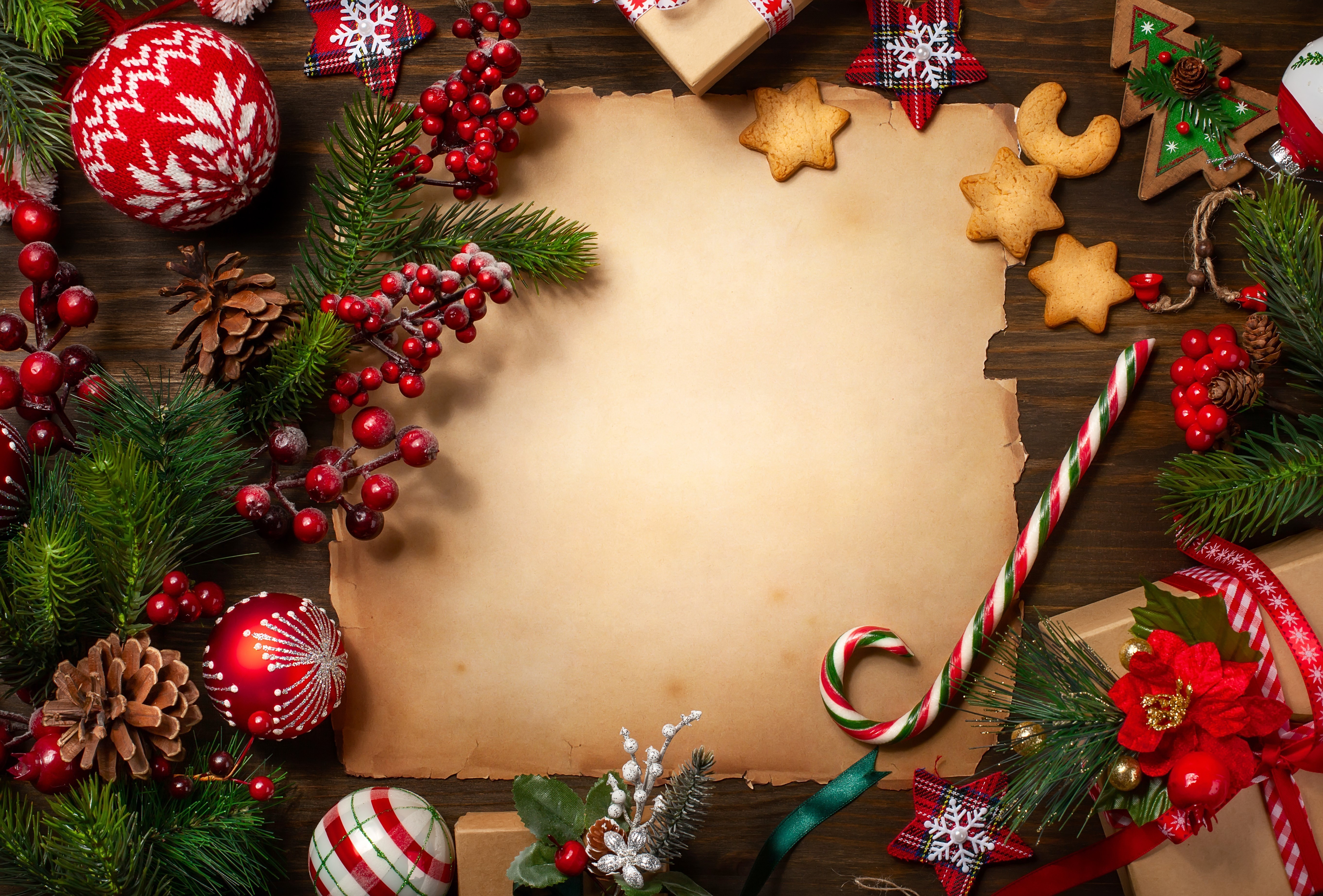 Christmas decorations and parchment paper on wooden table HD Wallpaper
