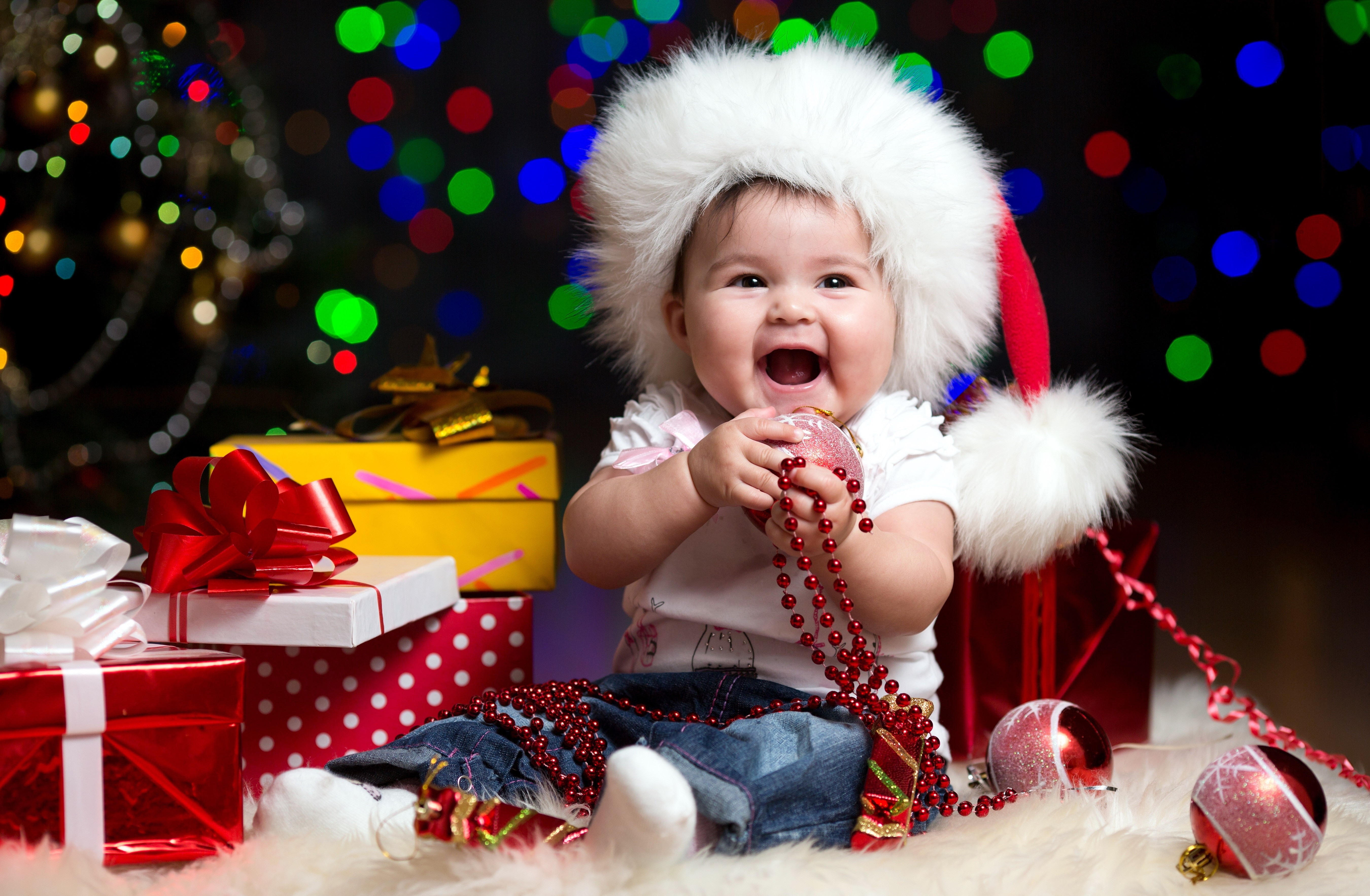 Baby in Santa hat with Christmas gifts HD Wallpaper