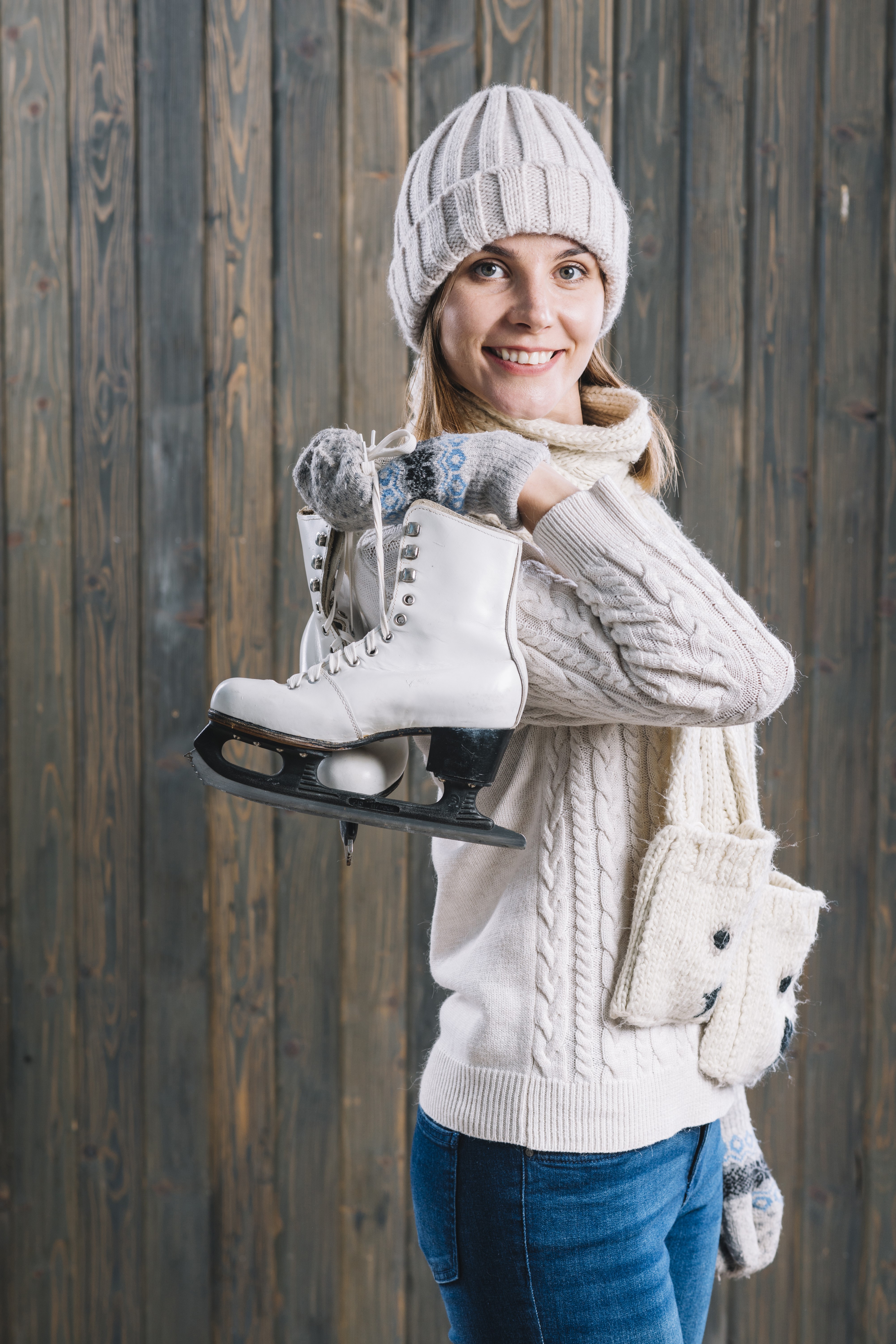 Woman in Winter Hat Holding Ice Skates HD Phone Wallpaper