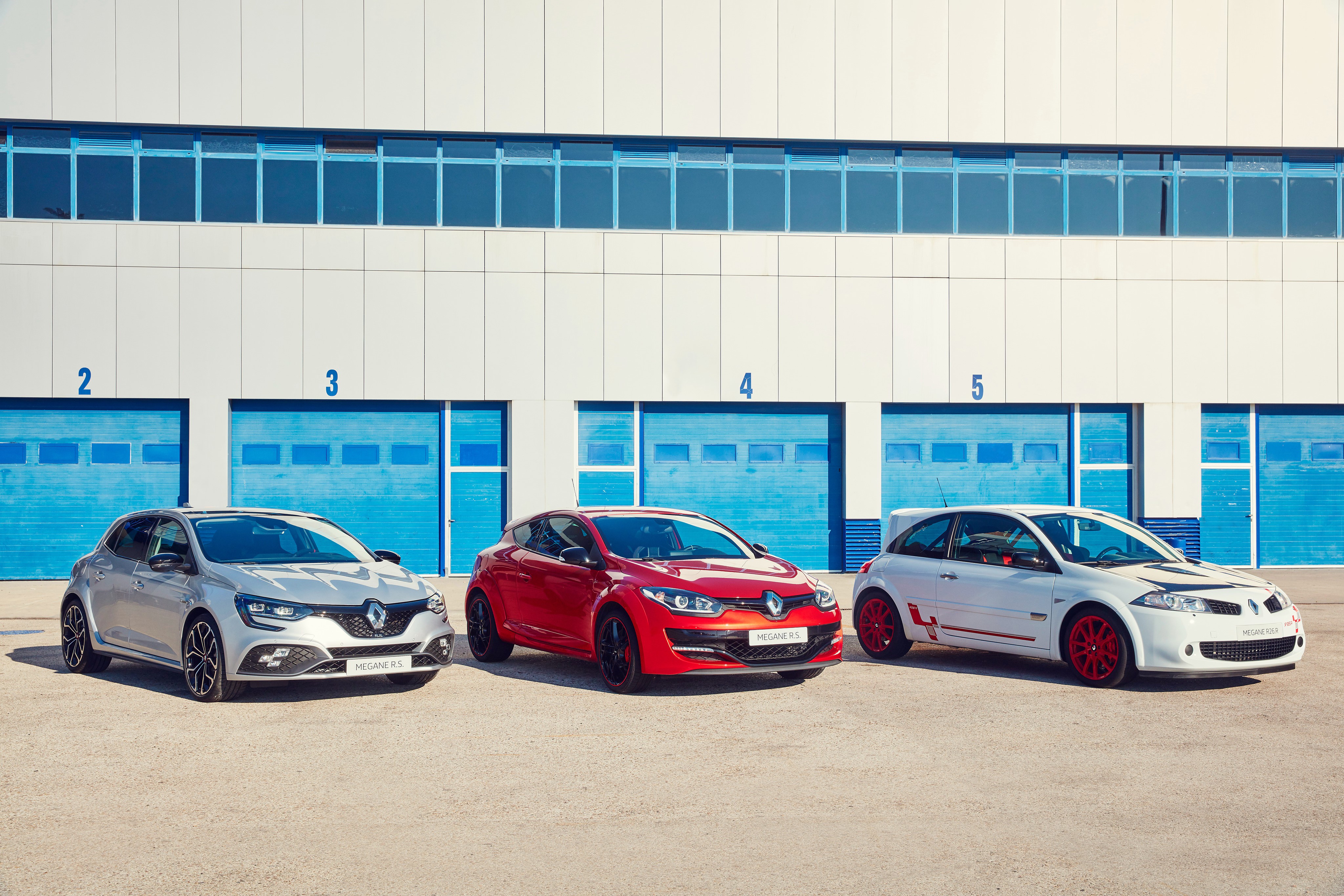 Three Renault Megane RS cars on a racetrack HD Wallpaper