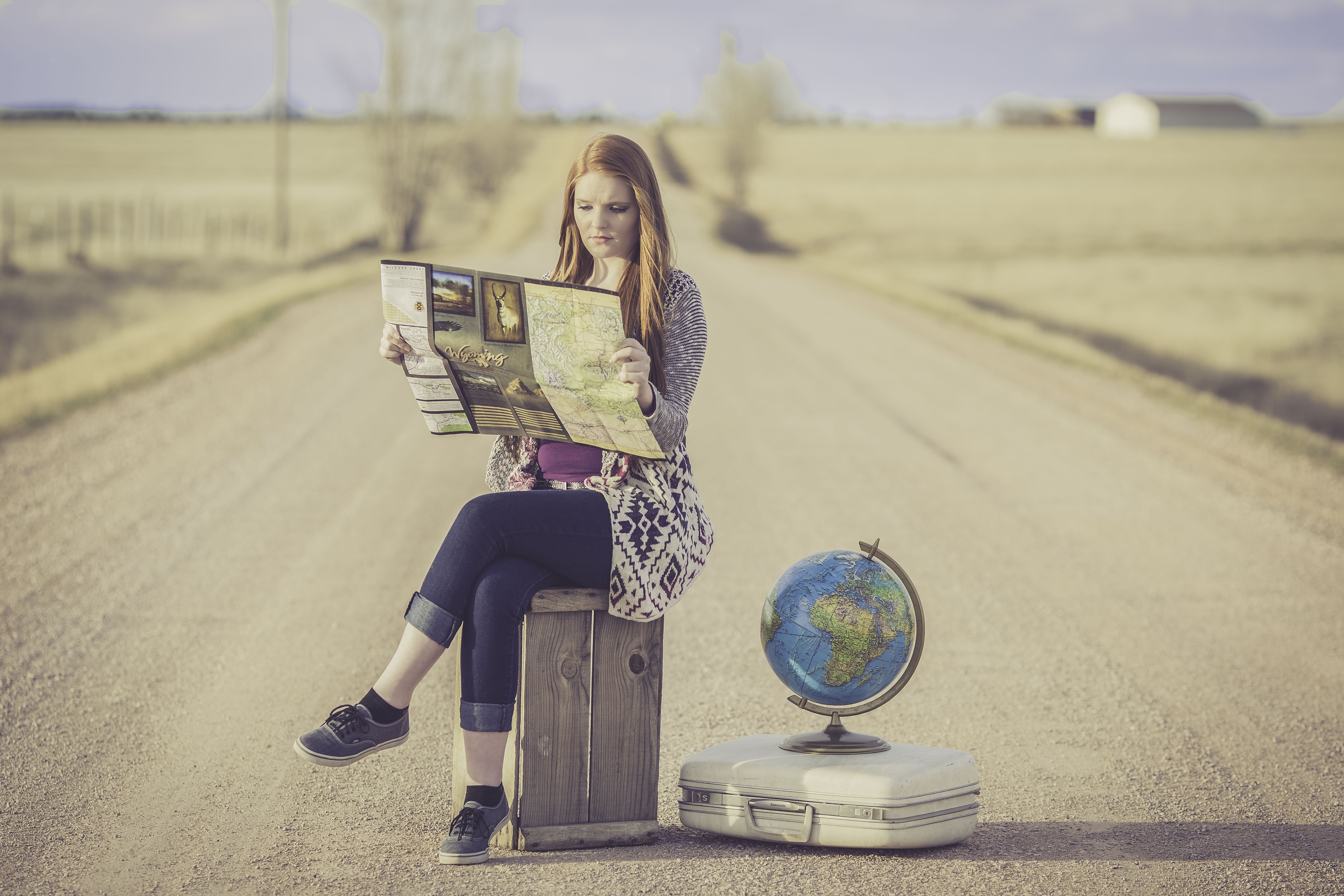 Woman with Map and Globe on Road HD Wallpaper