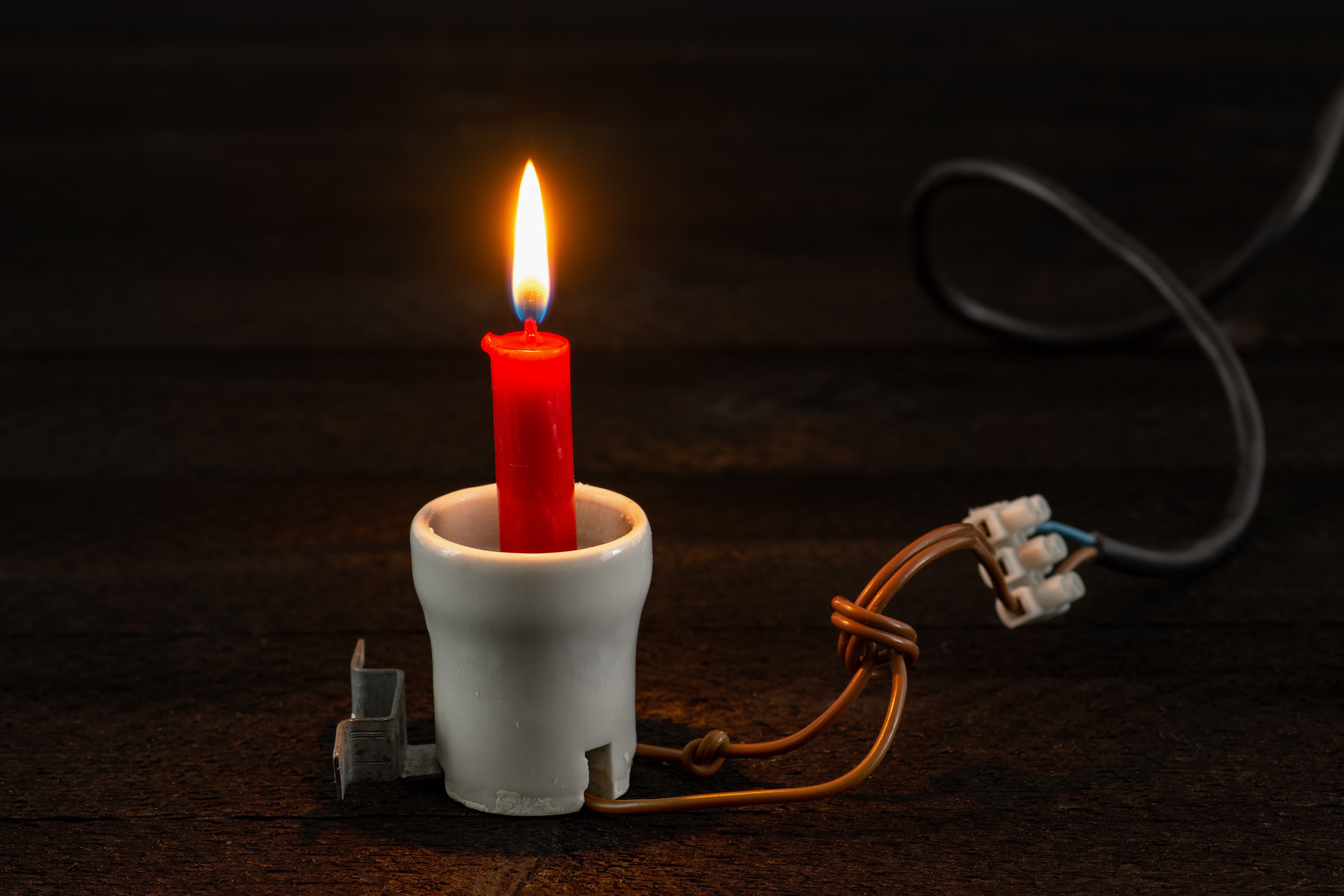 Candle in a light socket with electrical wires HD Wallpaper