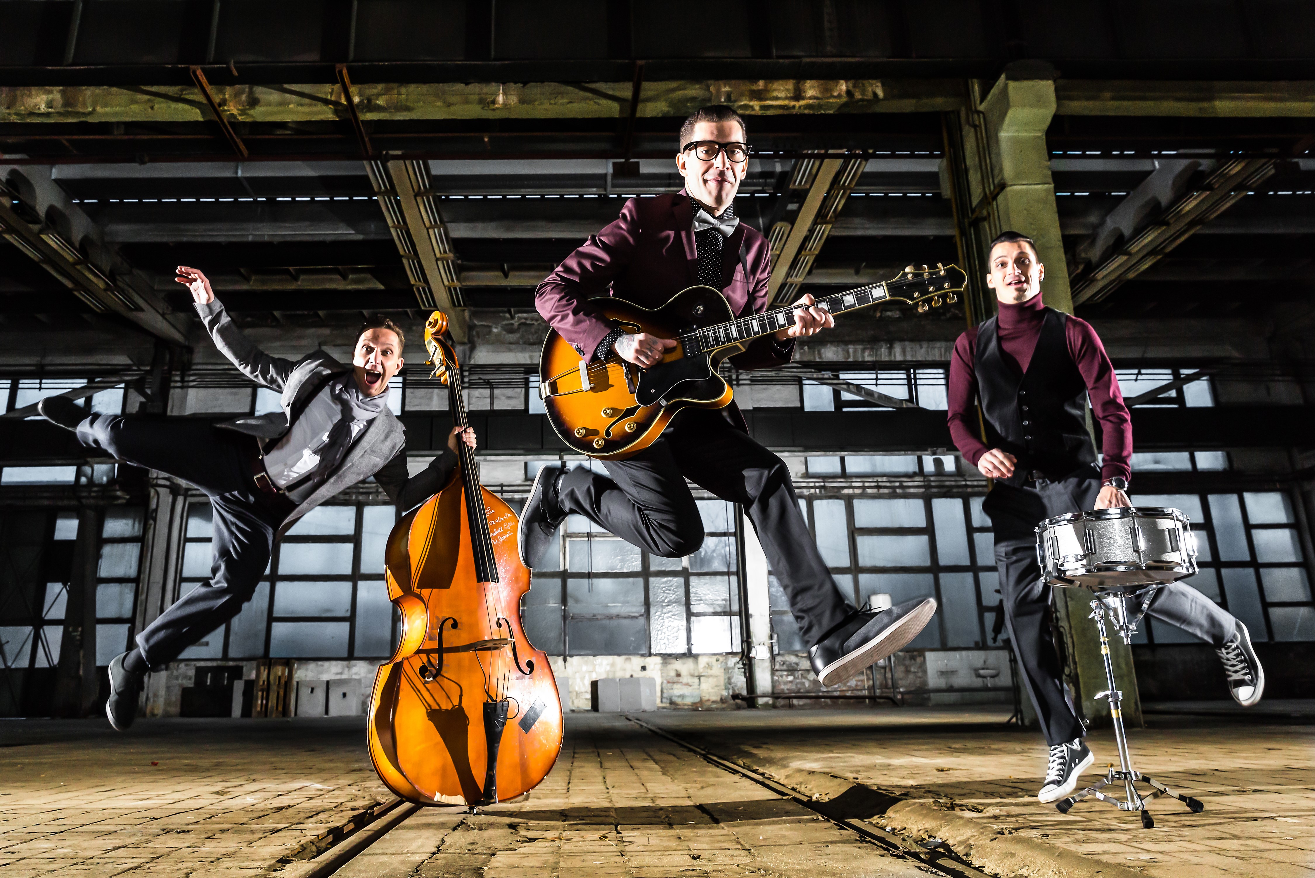Three Men Playing Musical Instruments and Jumping HD Wallpaper