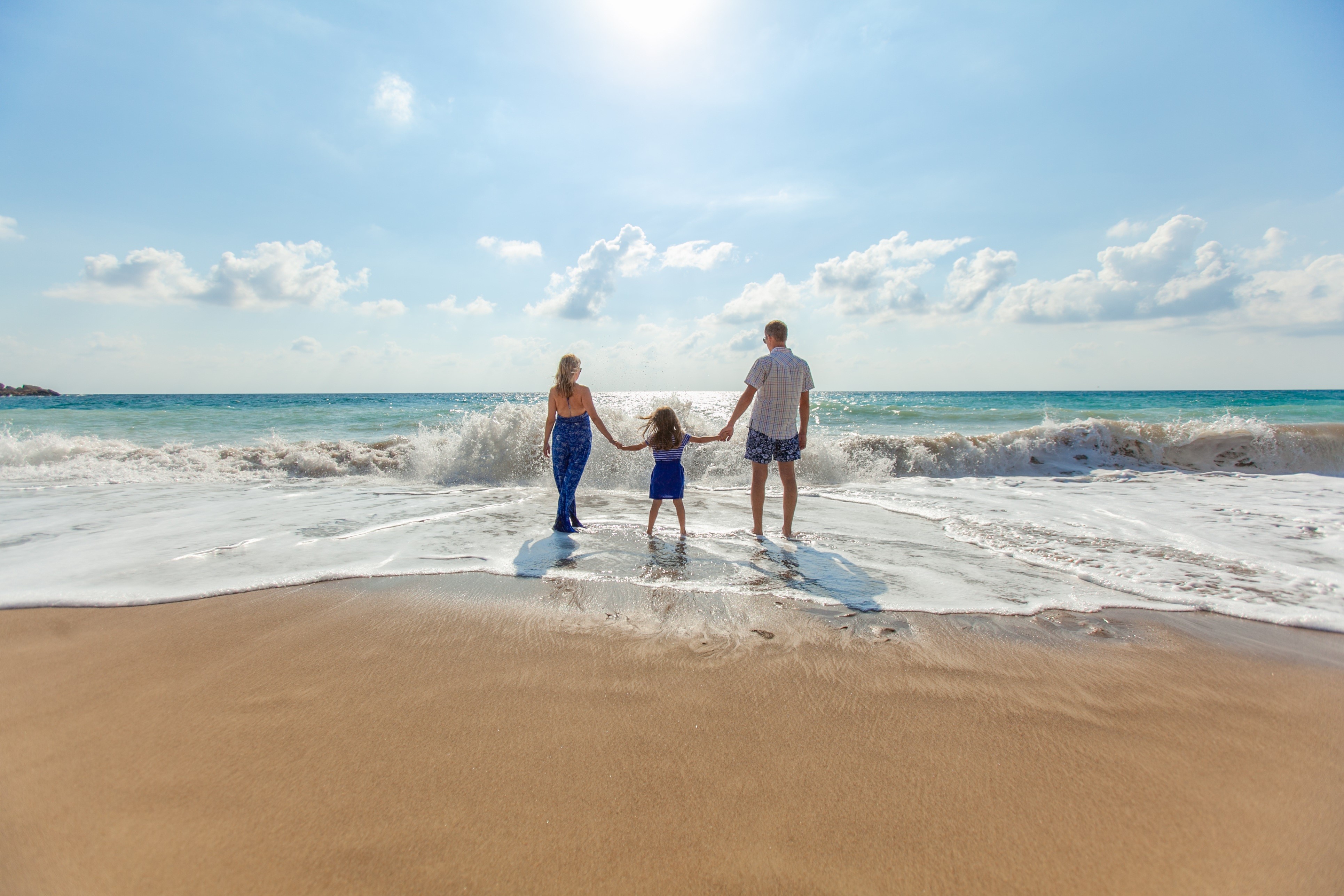 Family on Beach with Waves HD Wallpaper