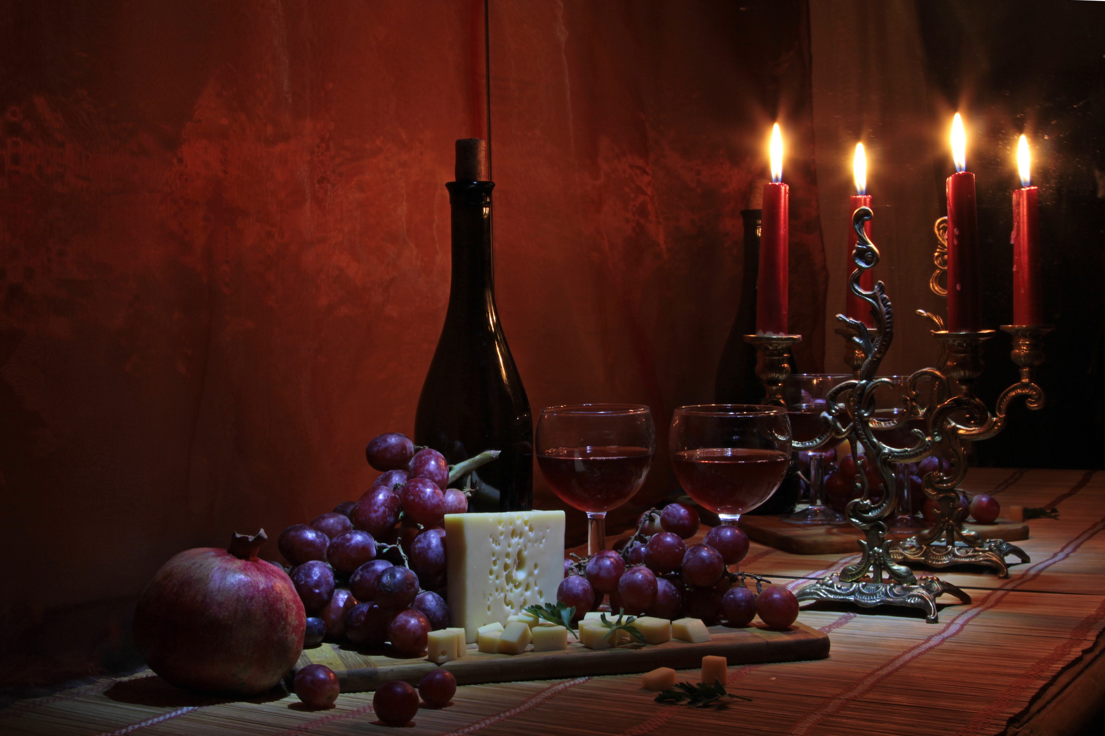 Still-life with wine, grapes, cheese, pomegranate, and candles HD Wallpaper
