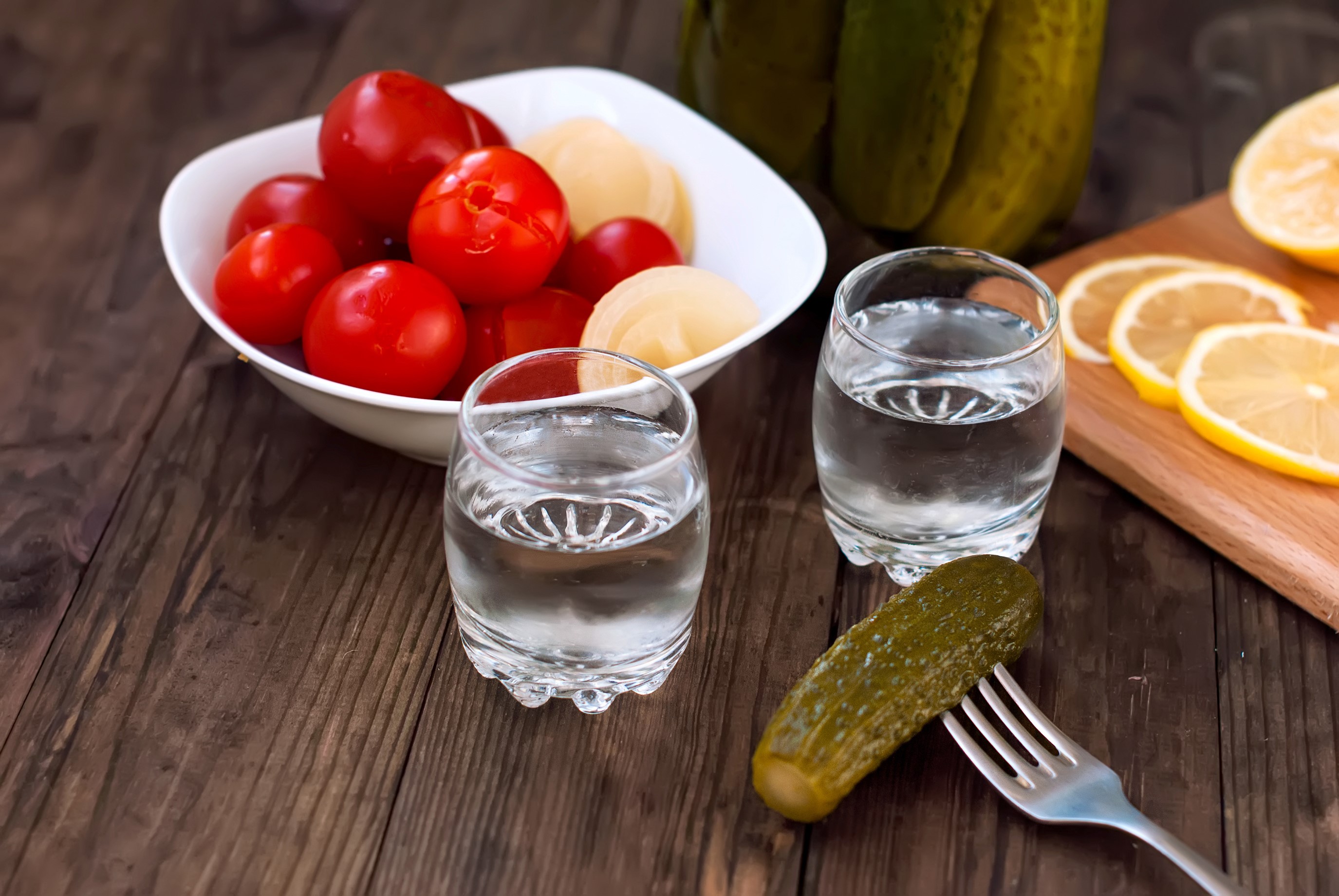 Vodka shots with pickles, tomatoes, and lemon slices HD Wallpaper