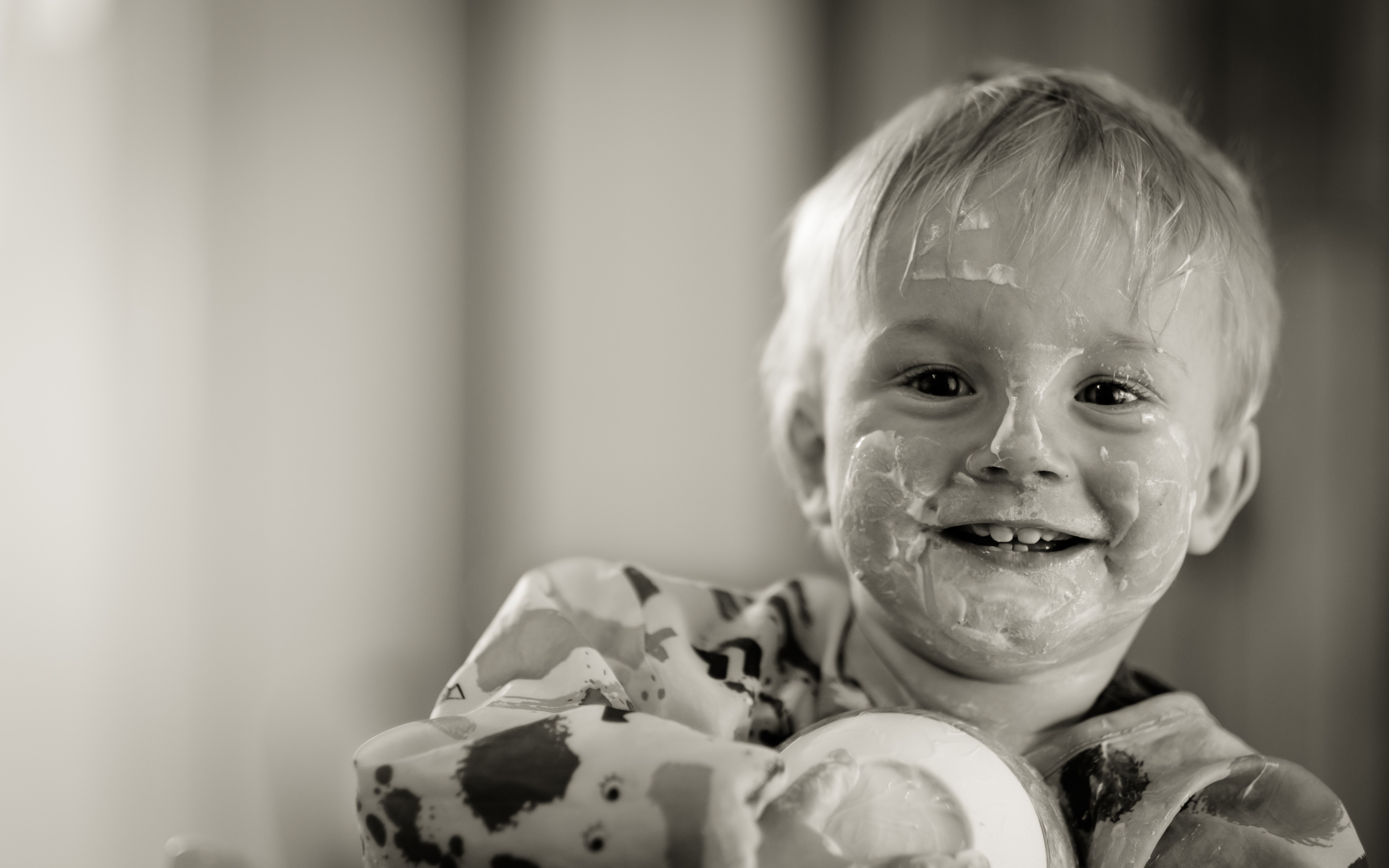 Boy with yogurt on his face smiling HD Wallpaper