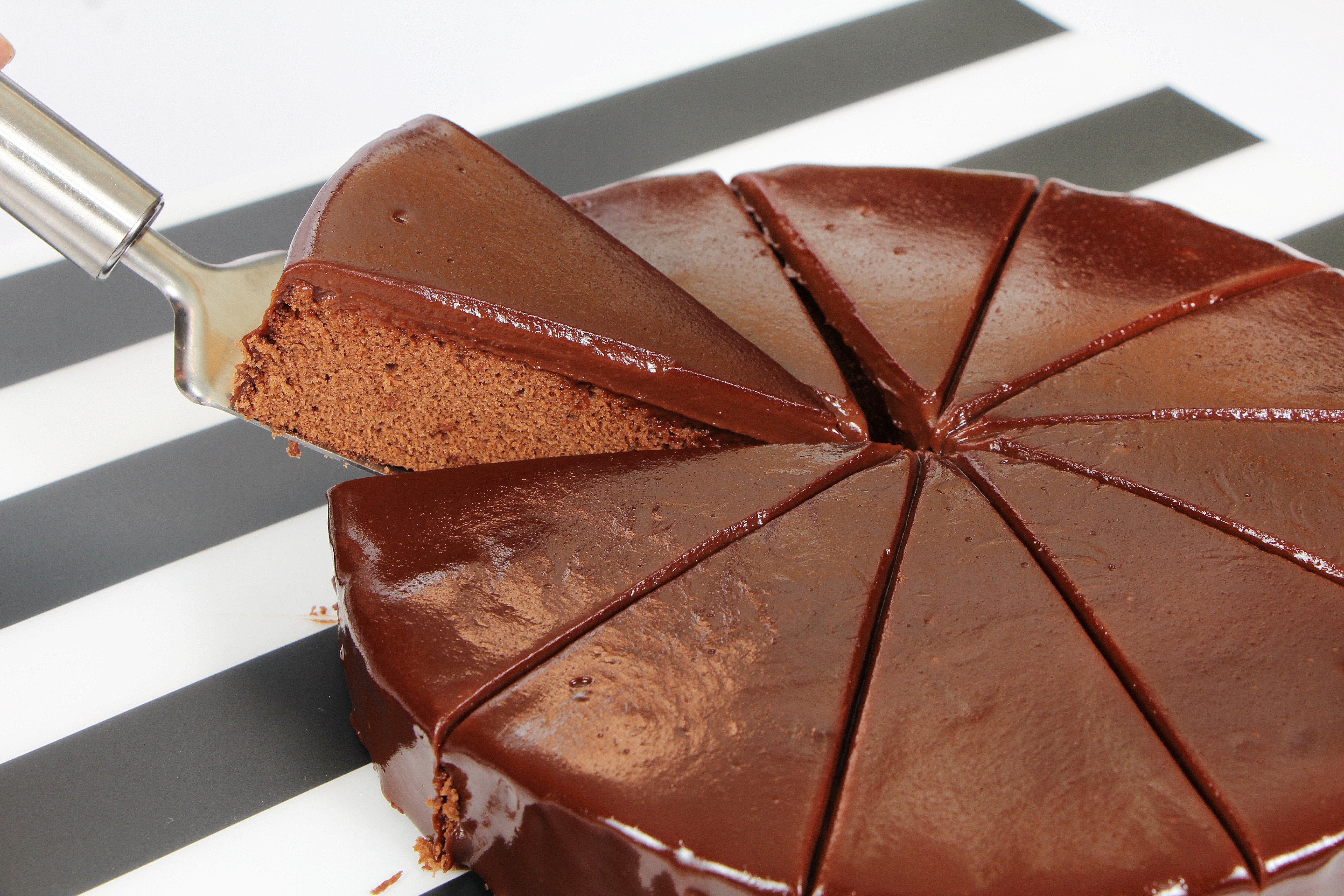 Chocolate cake with a slice being served HD Wallpaper