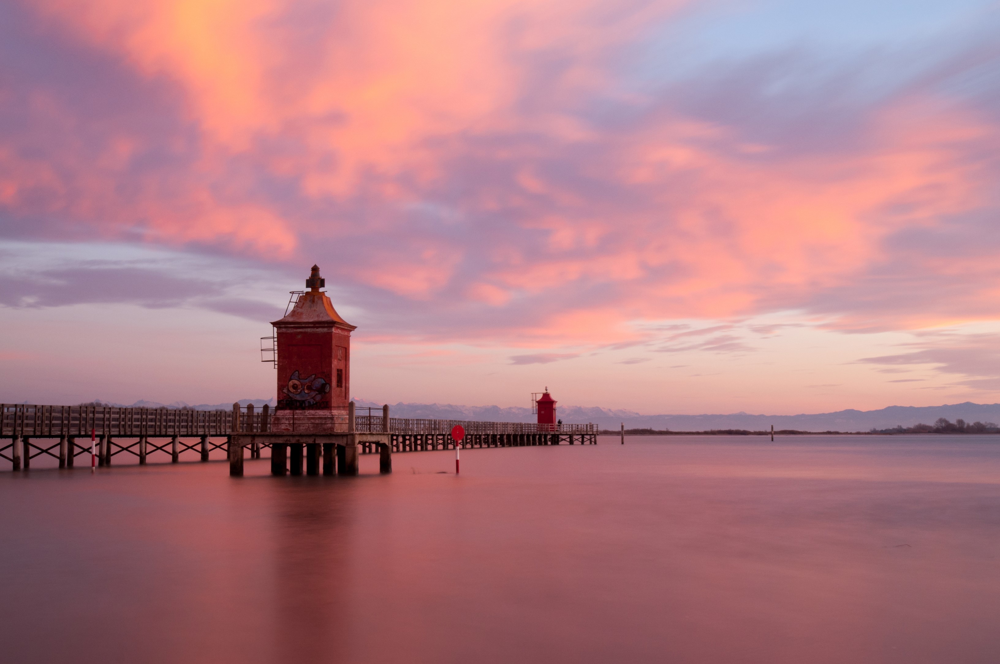 Two lighthouses on a pier at Sabbiadoro, Italy during sunset HD Wallpaper