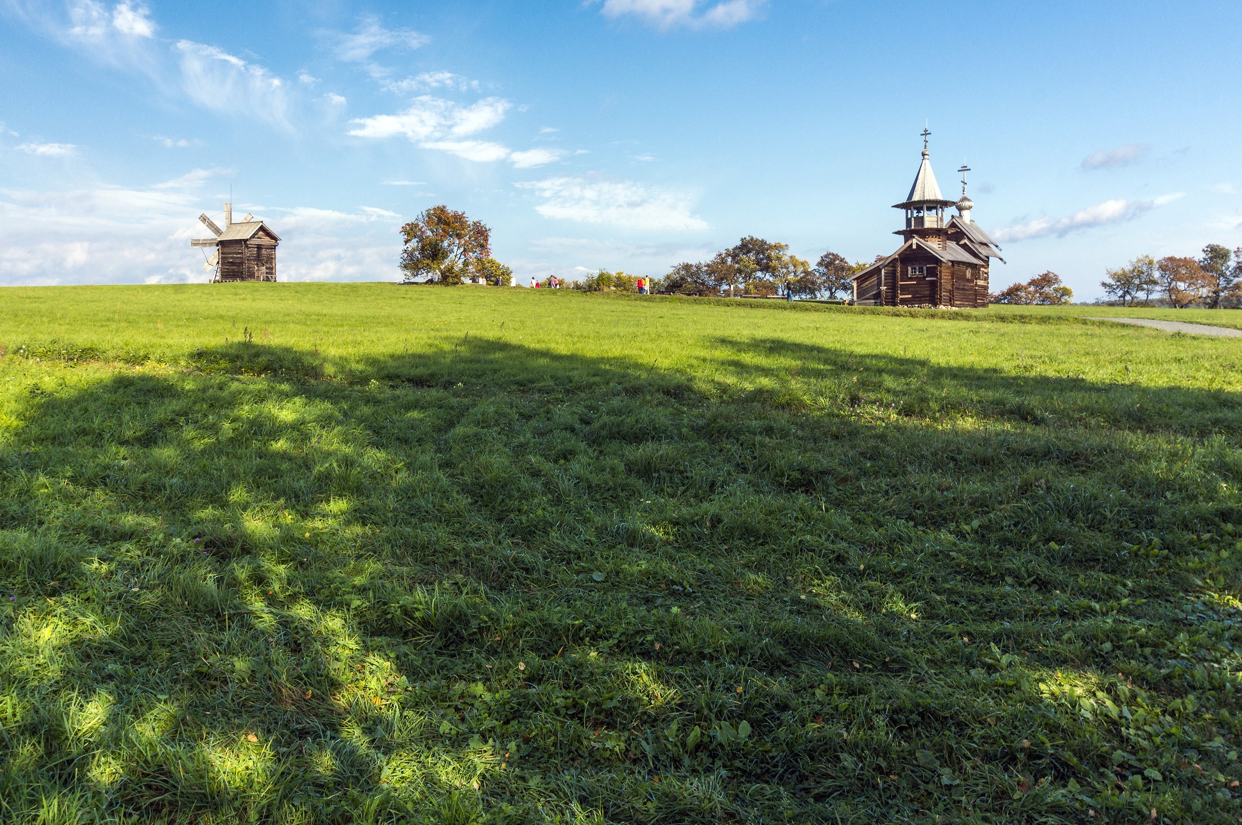 Wooden church and windmill on a grassy hill in Kizhi, Russia HD Wallpaper