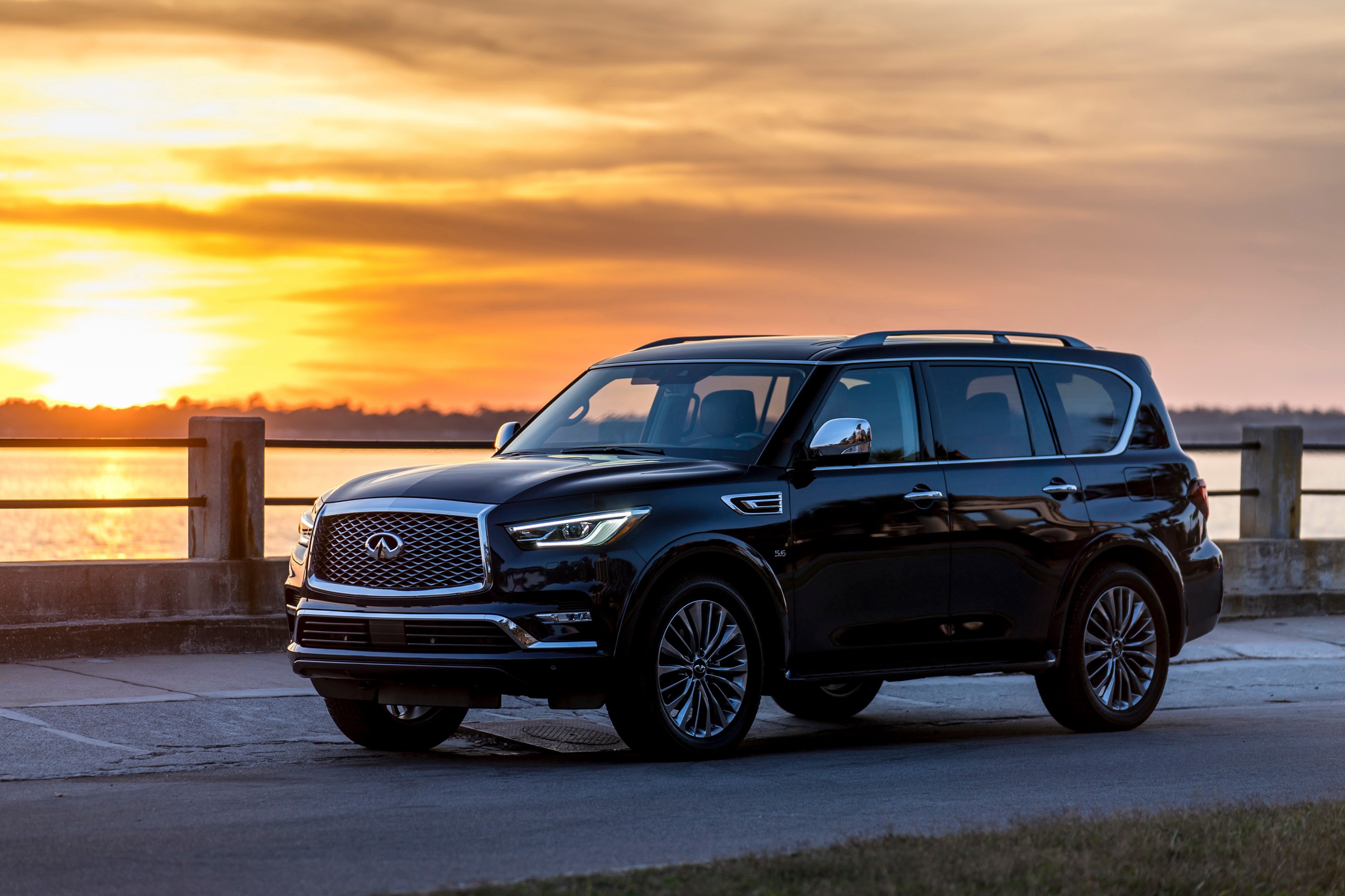 Black Infiniti QX80 SUV at sunset HD Wallpaper