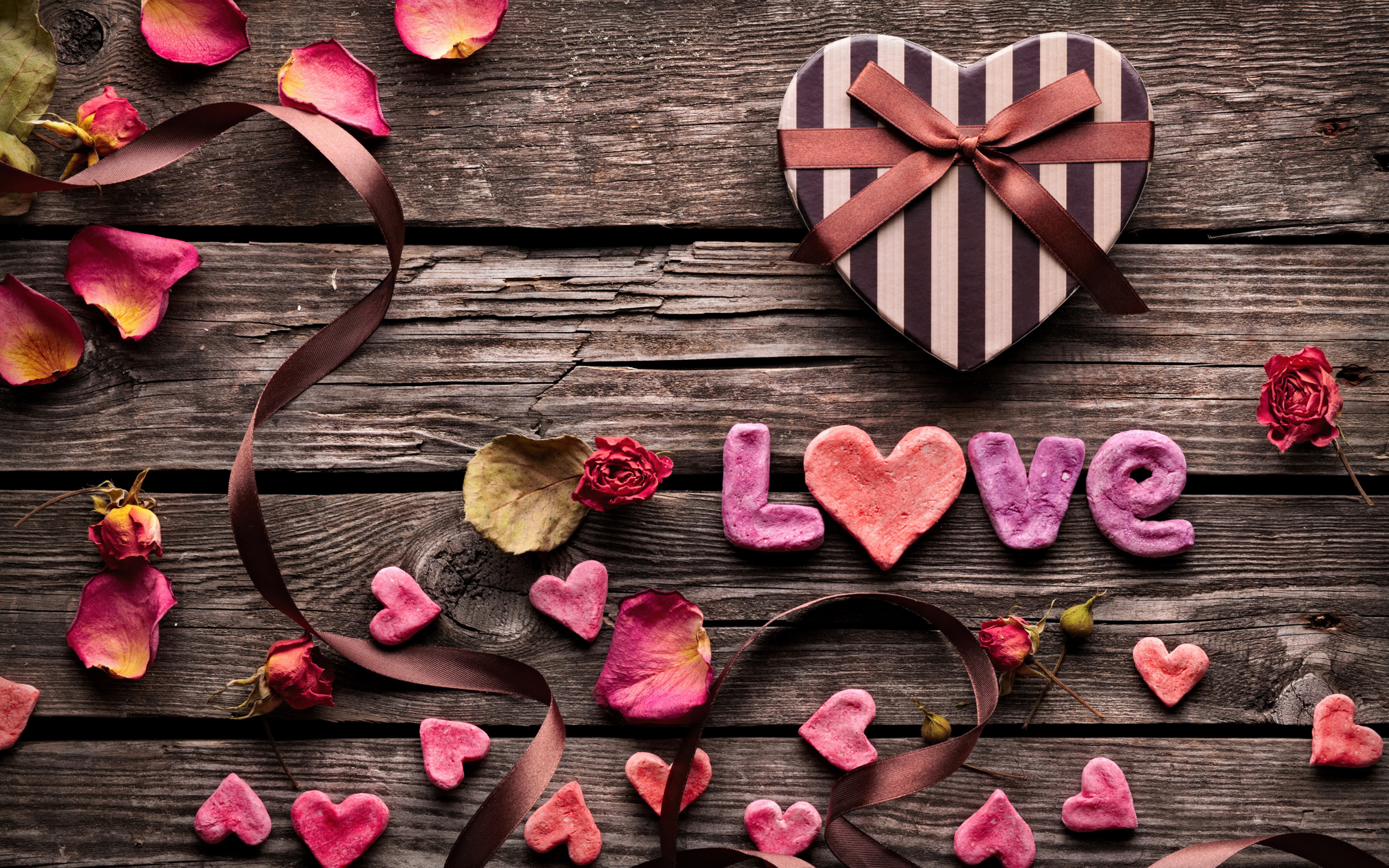 Love letters and heart-shaped gift on wooden planks HD Wallpaper