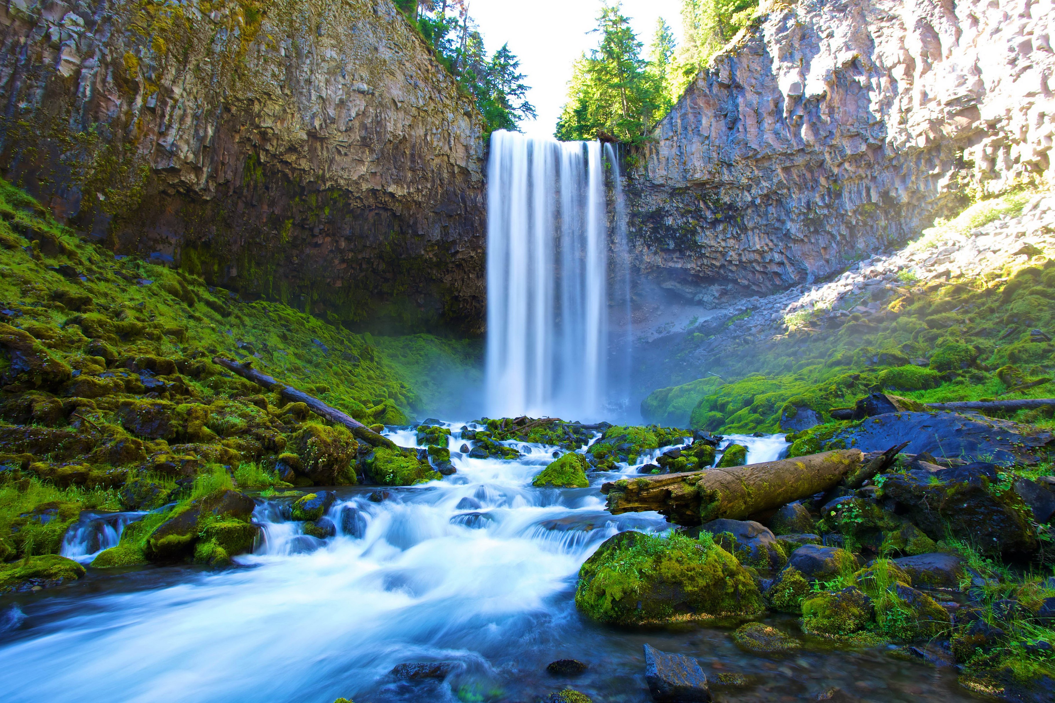 Waterfall cascading over mossy rocks and cliffs HD Wallpaper