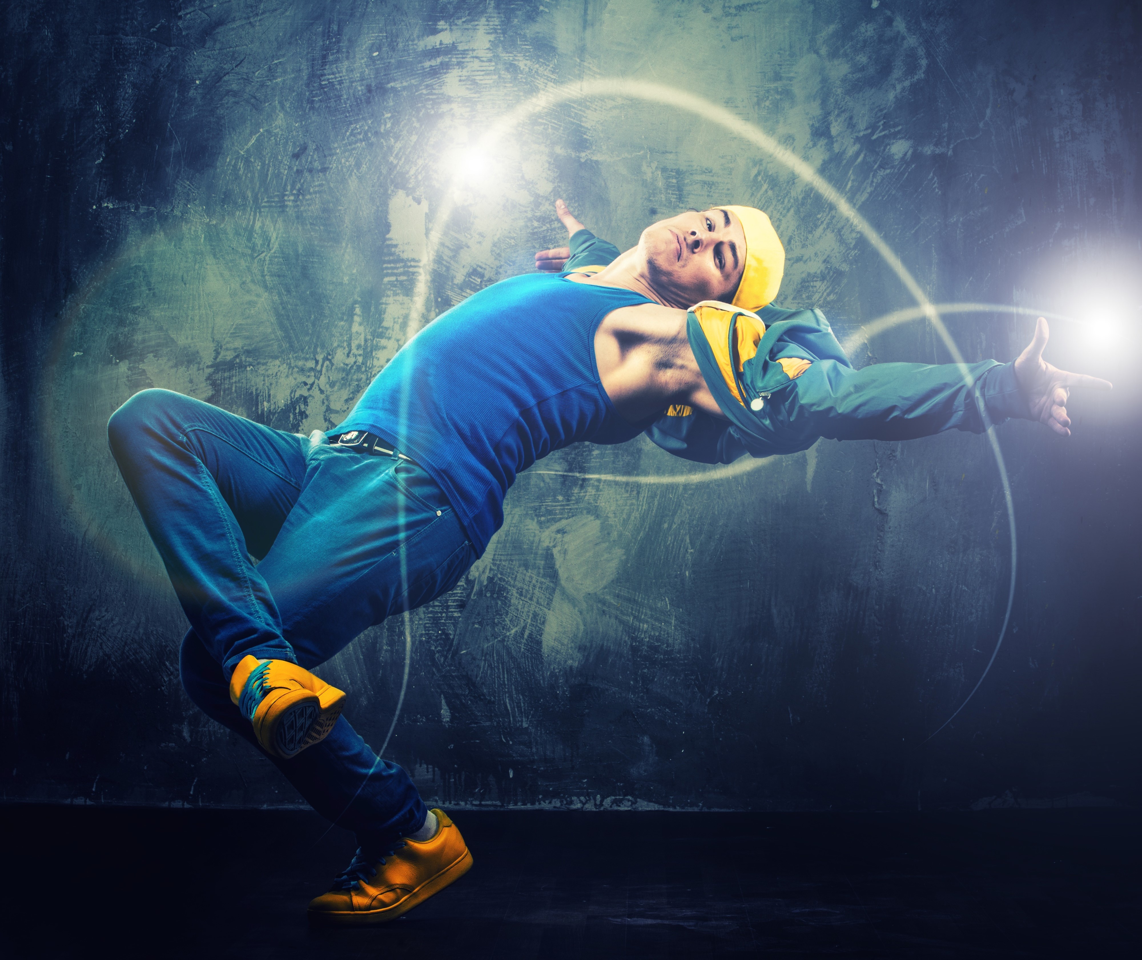 Man dancing in blue tank top and yellow hat HD Wallpaper