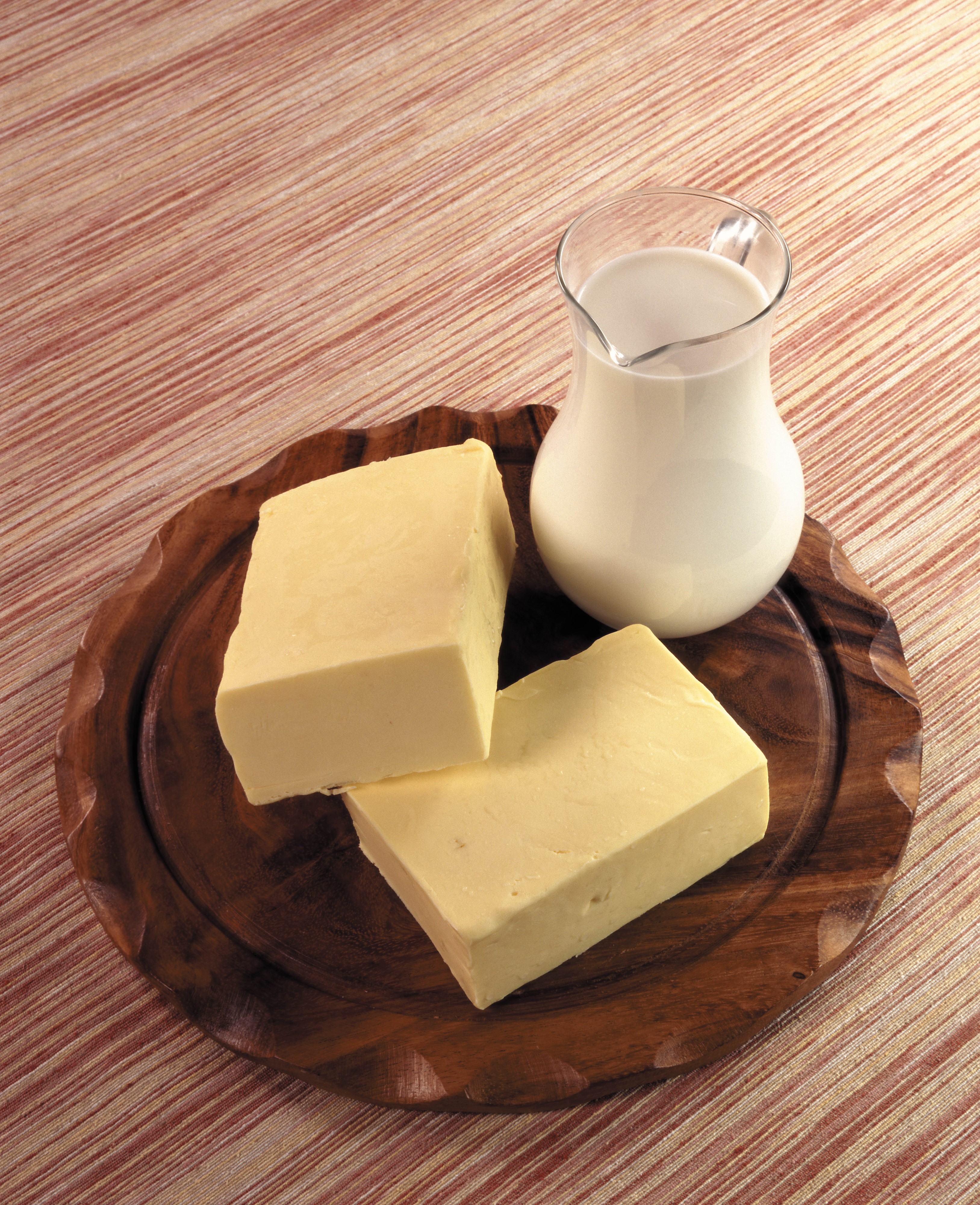 Butter and milk in a pitcher on a wooden plate HD Phone Wallpaper