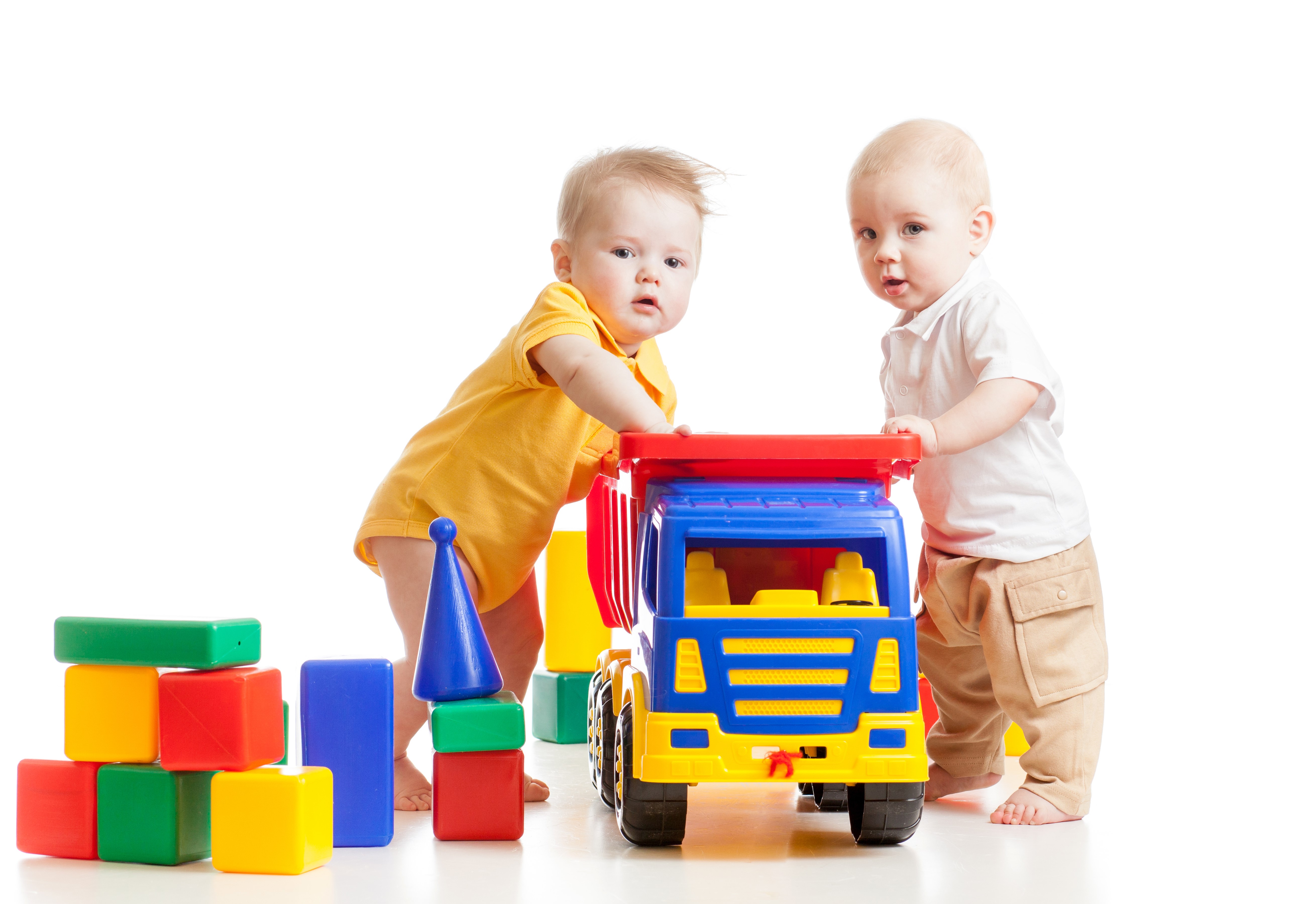 Two babies playing with toys on white background HD Wallpaper