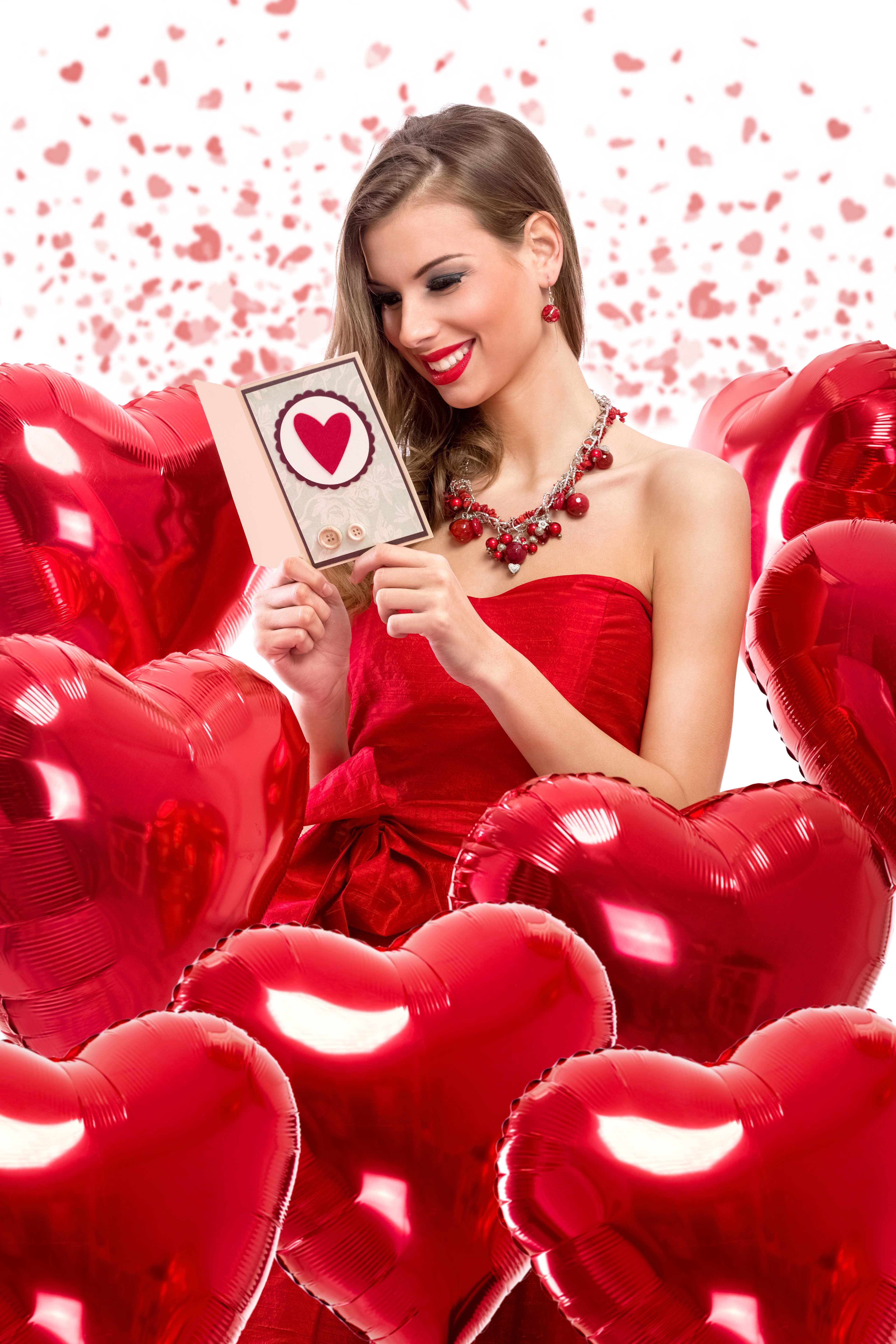 Woman in red dress holding Valentine's Day card with heart balloons HD Phone Wallpaper