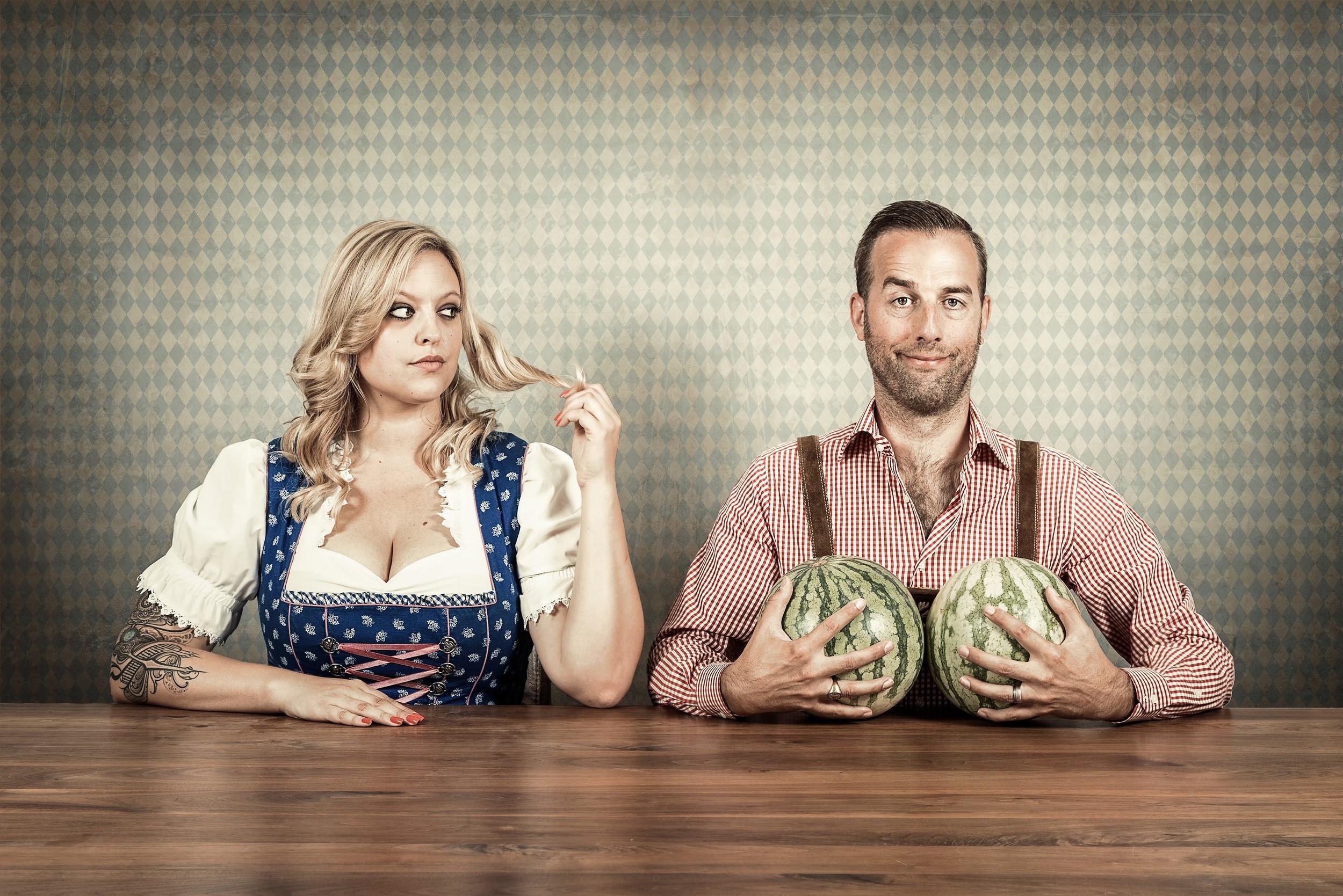 Couple with watermelons in traditional German attire HD Wallpaper