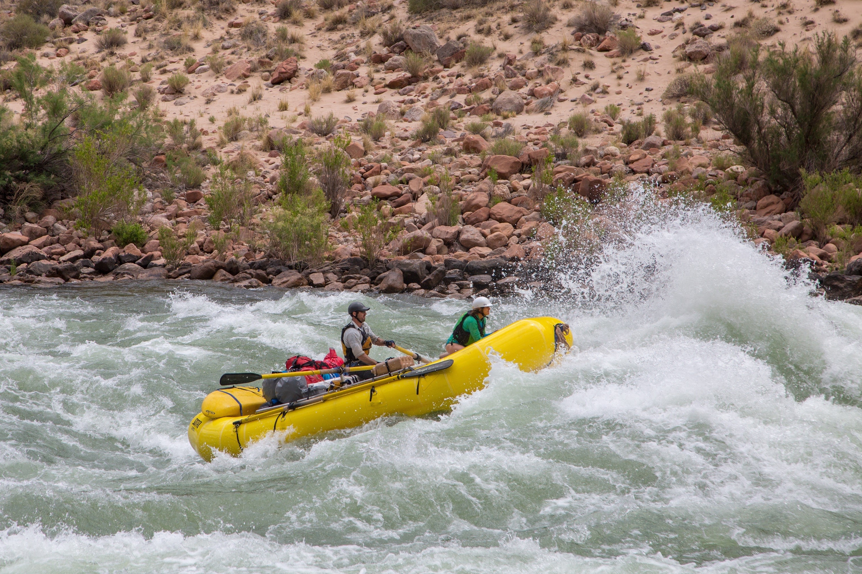 Two people white water rafting in a river HD Wallpaper