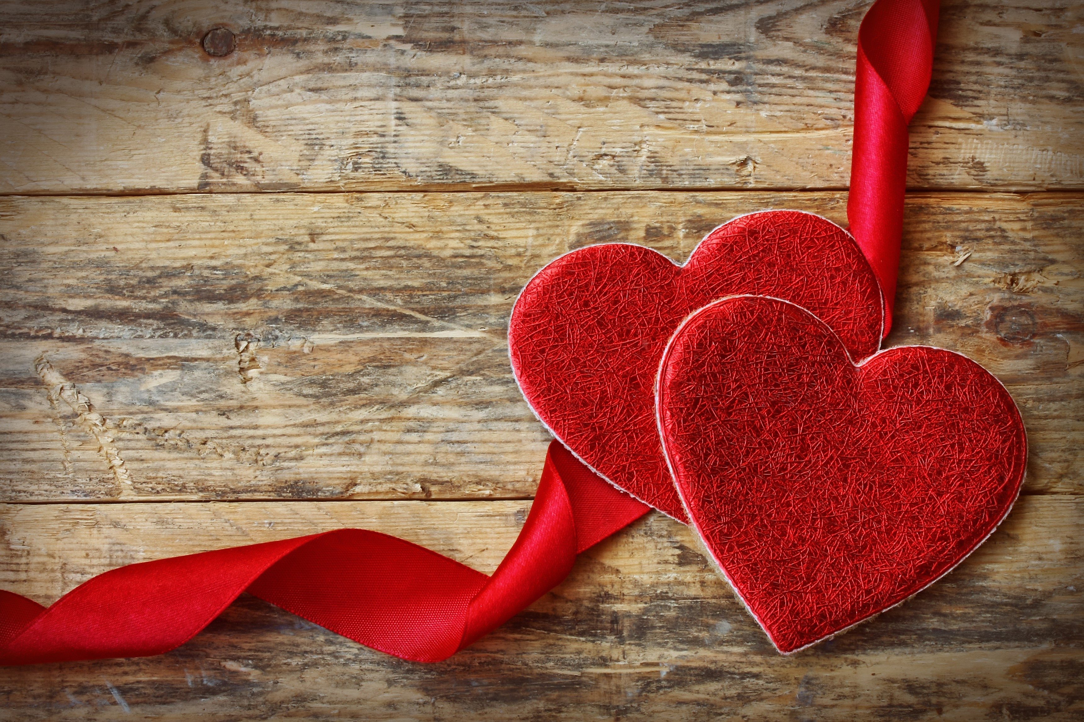 Two red hearts with red ribbon on wood planks HD Wallpaper