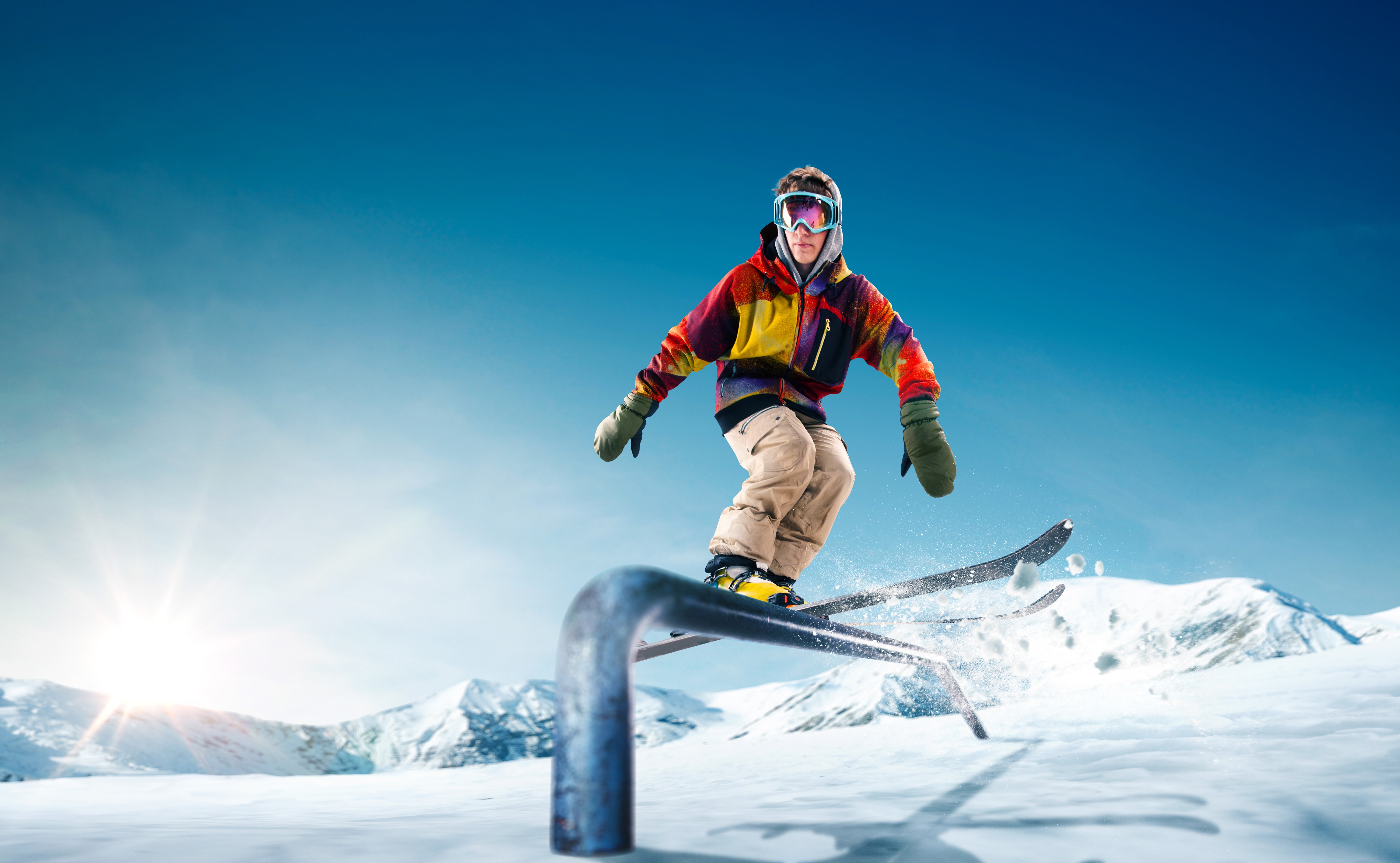 Man skiing on a rail in the mountains HD Wallpaper