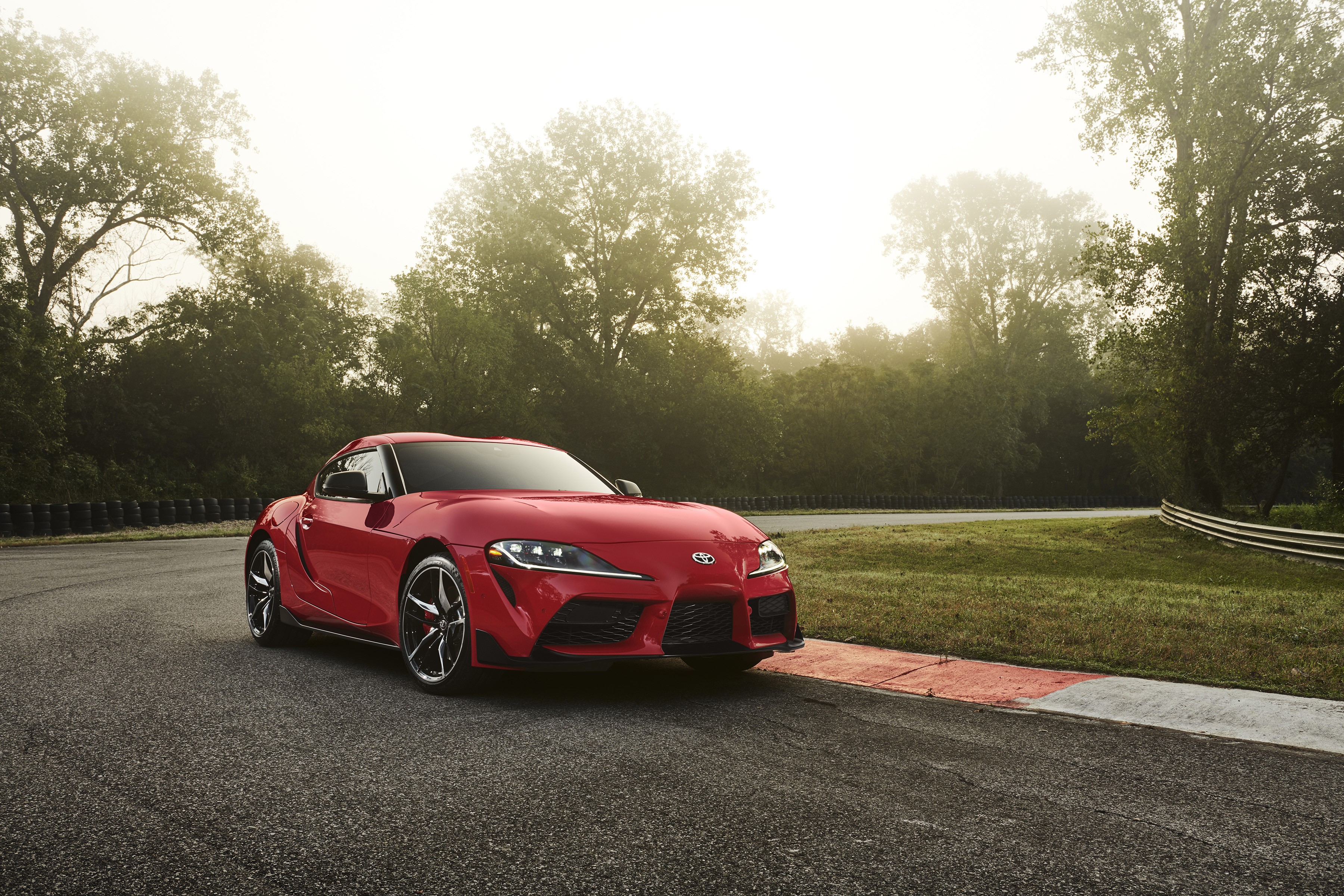 Red 2020 Toyota GR Supra on a Racetrack HD Wallpaper