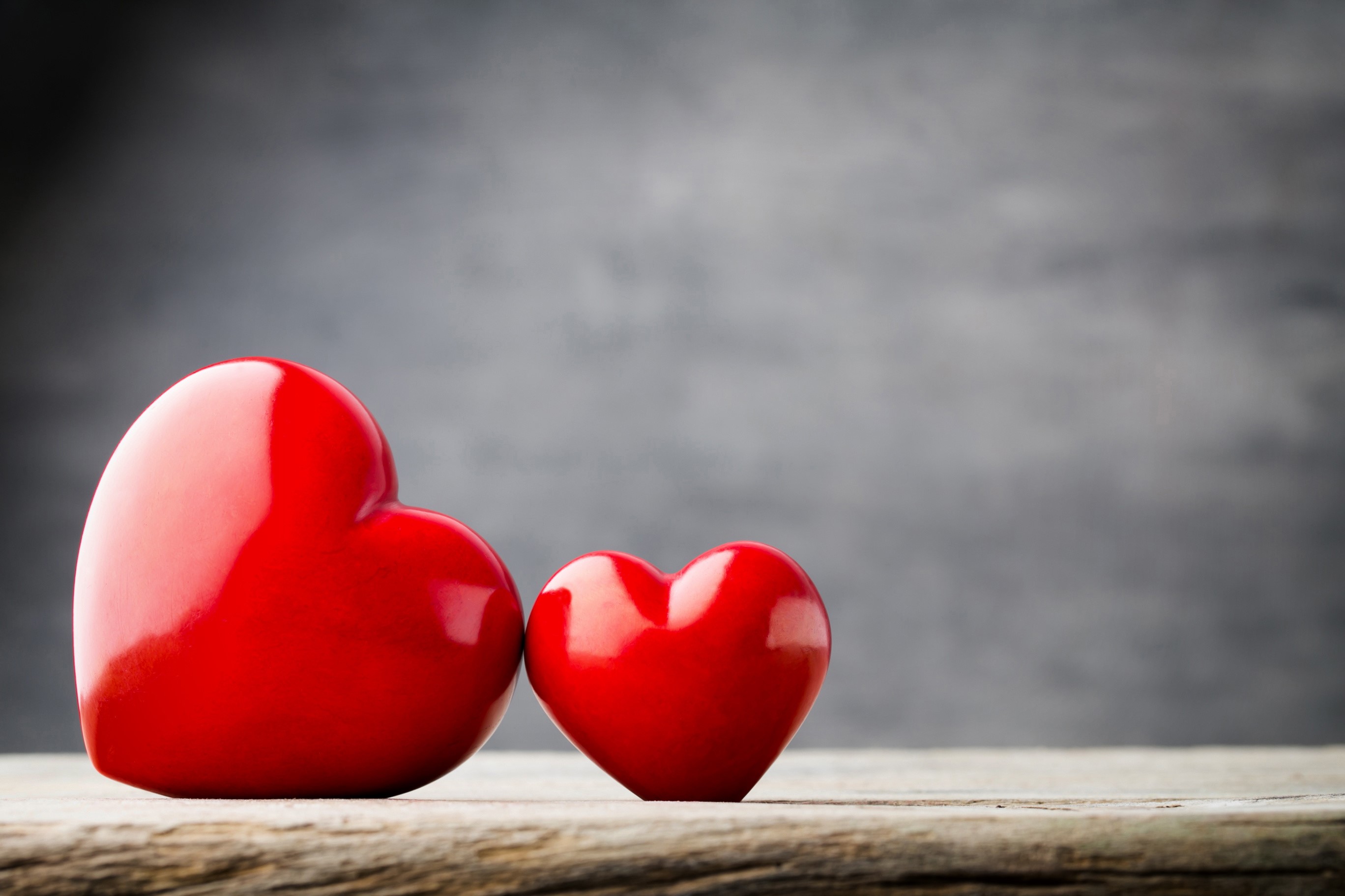 Two red hearts on a wooden surface HD Wallpaper