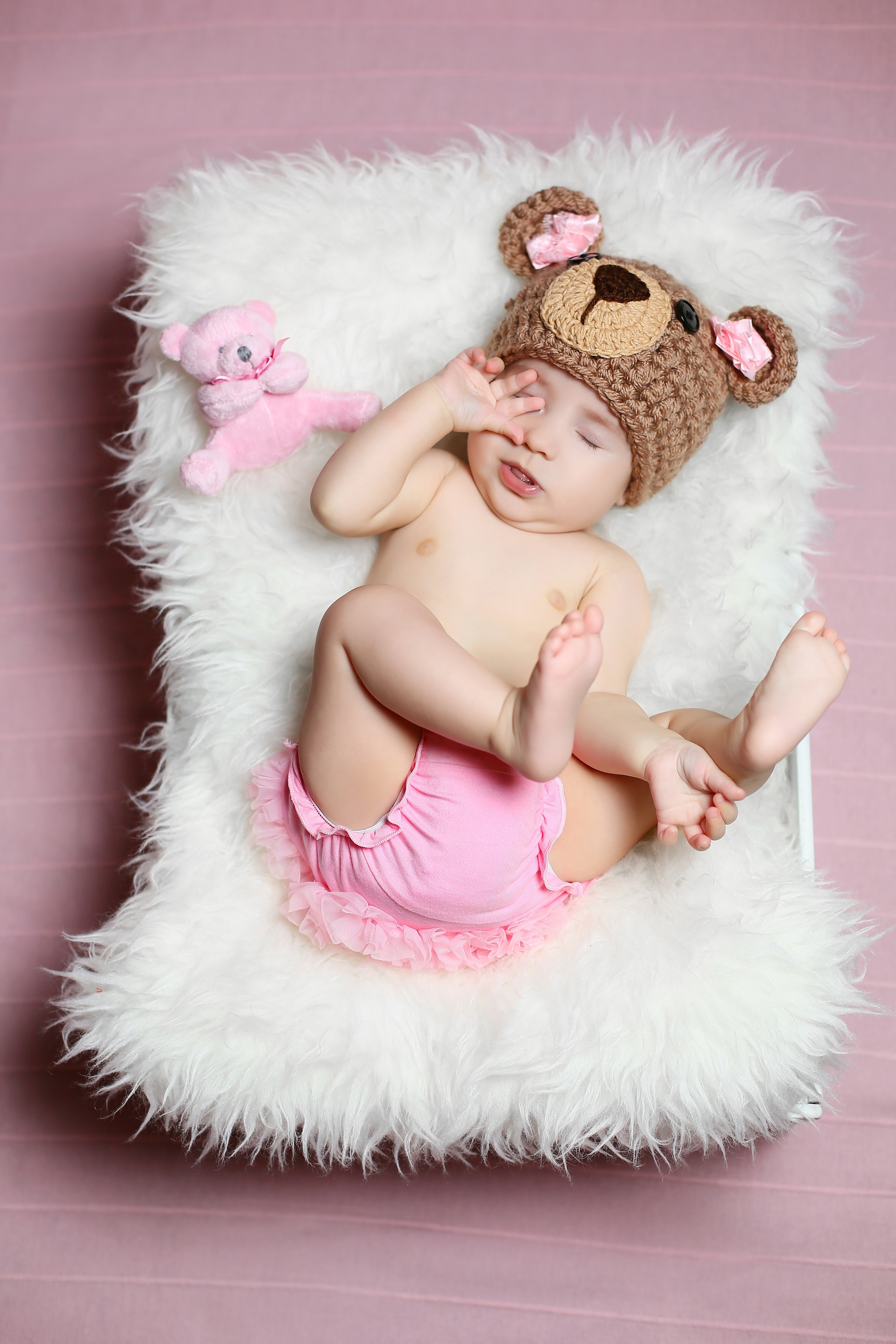 Baby wearing a teddy bear hat and pink bloomers HD Phone Wallpaper