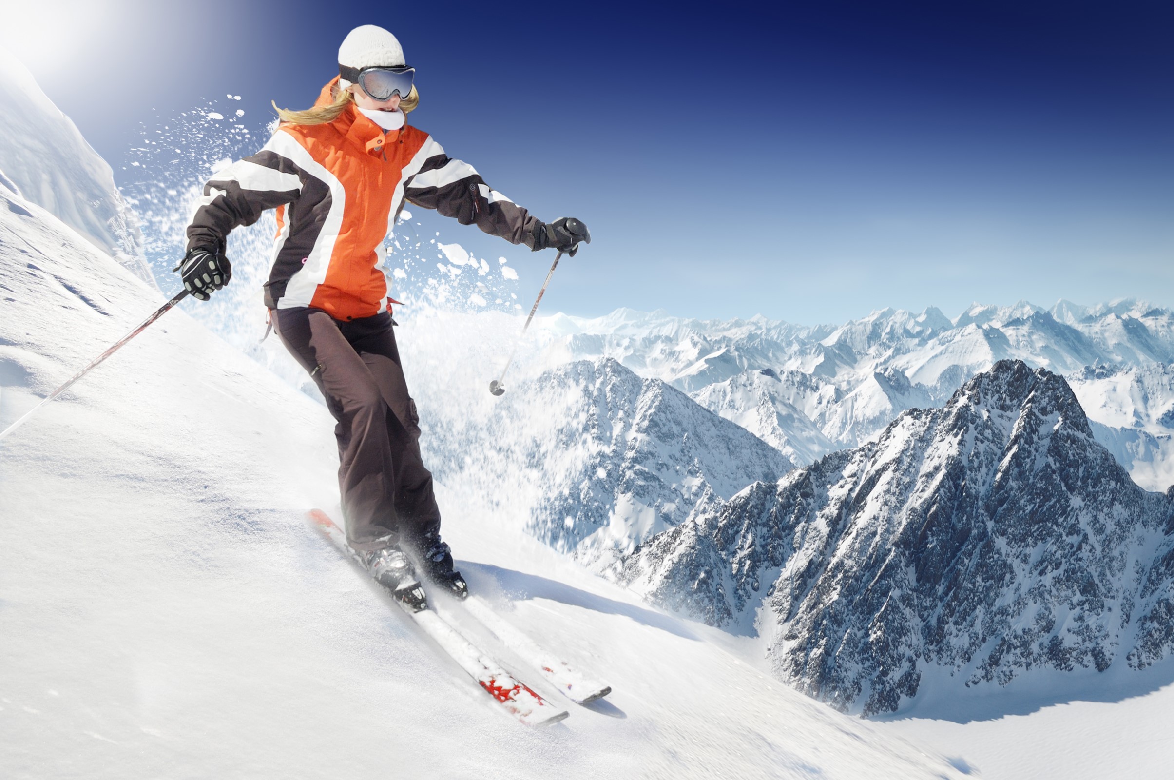 Woman skiing down a snowy mountain HD Wallpaper