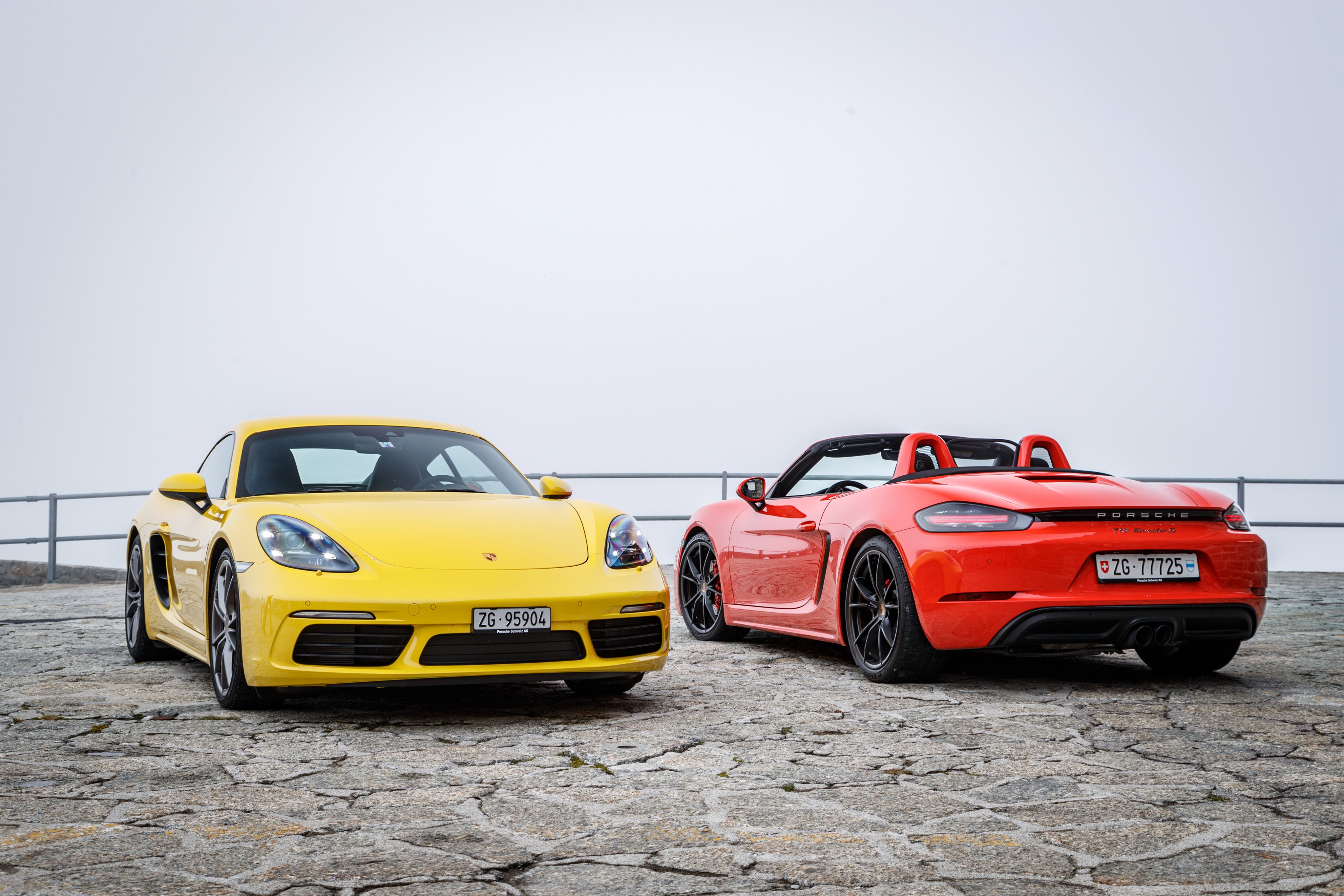Two Porsche 718 cars, yellow and red HD Wallpaper