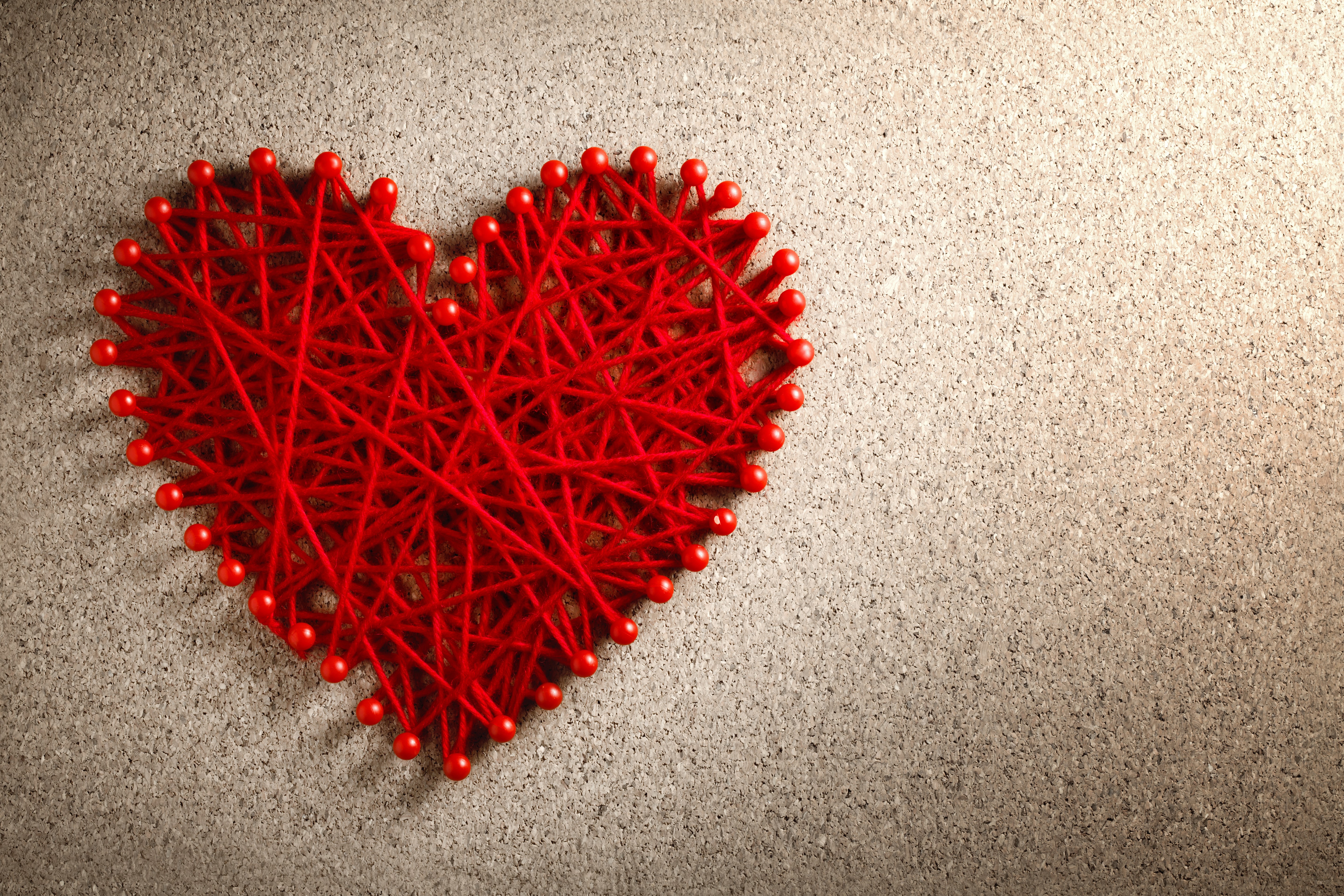 Red string heart on cork board HD Wallpaper