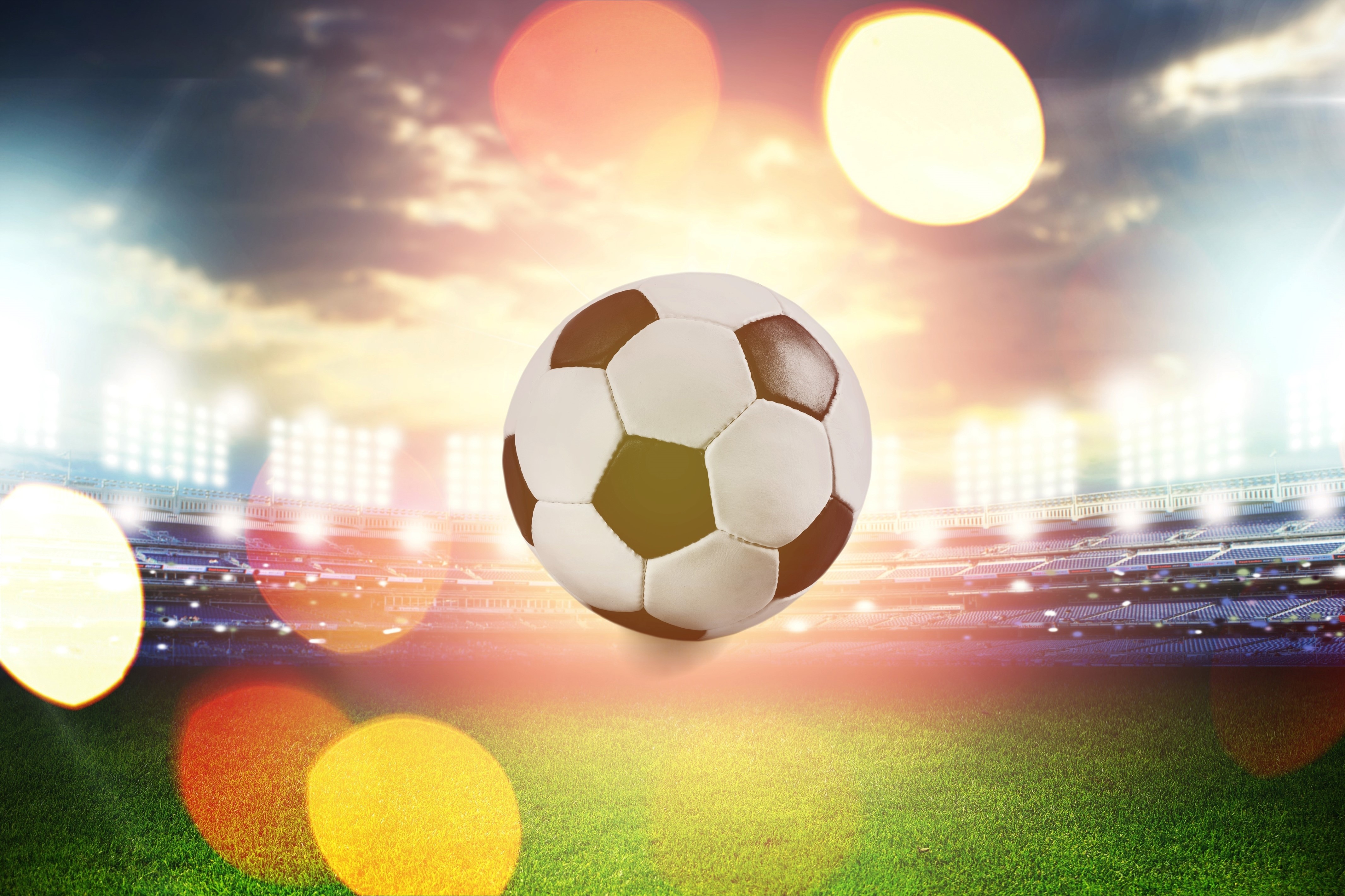 Soccer ball floating over a stadium field HD Wallpaper