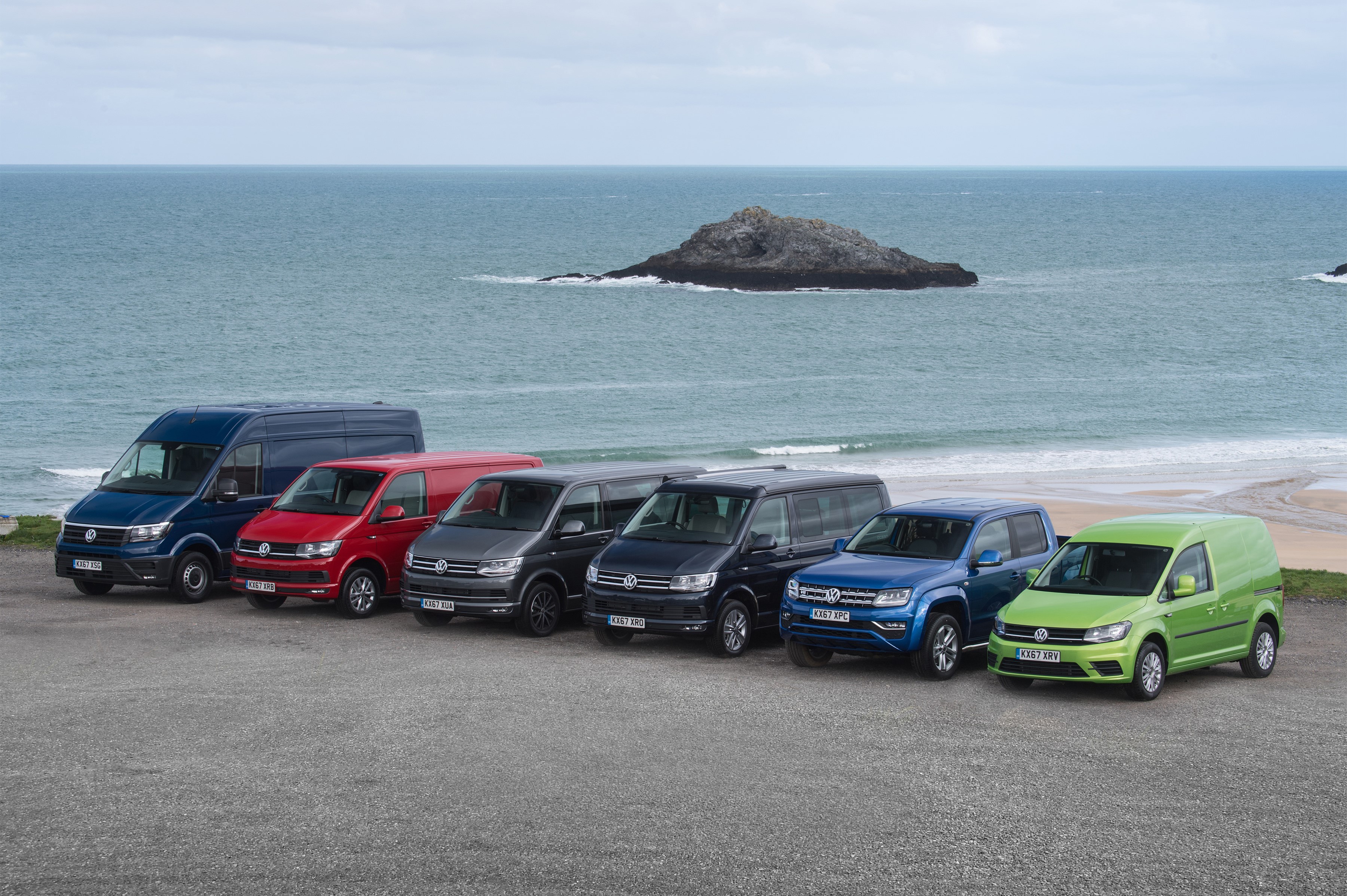 Volkswagen vans and pickup truck lineup by the sea HD Wallpaper