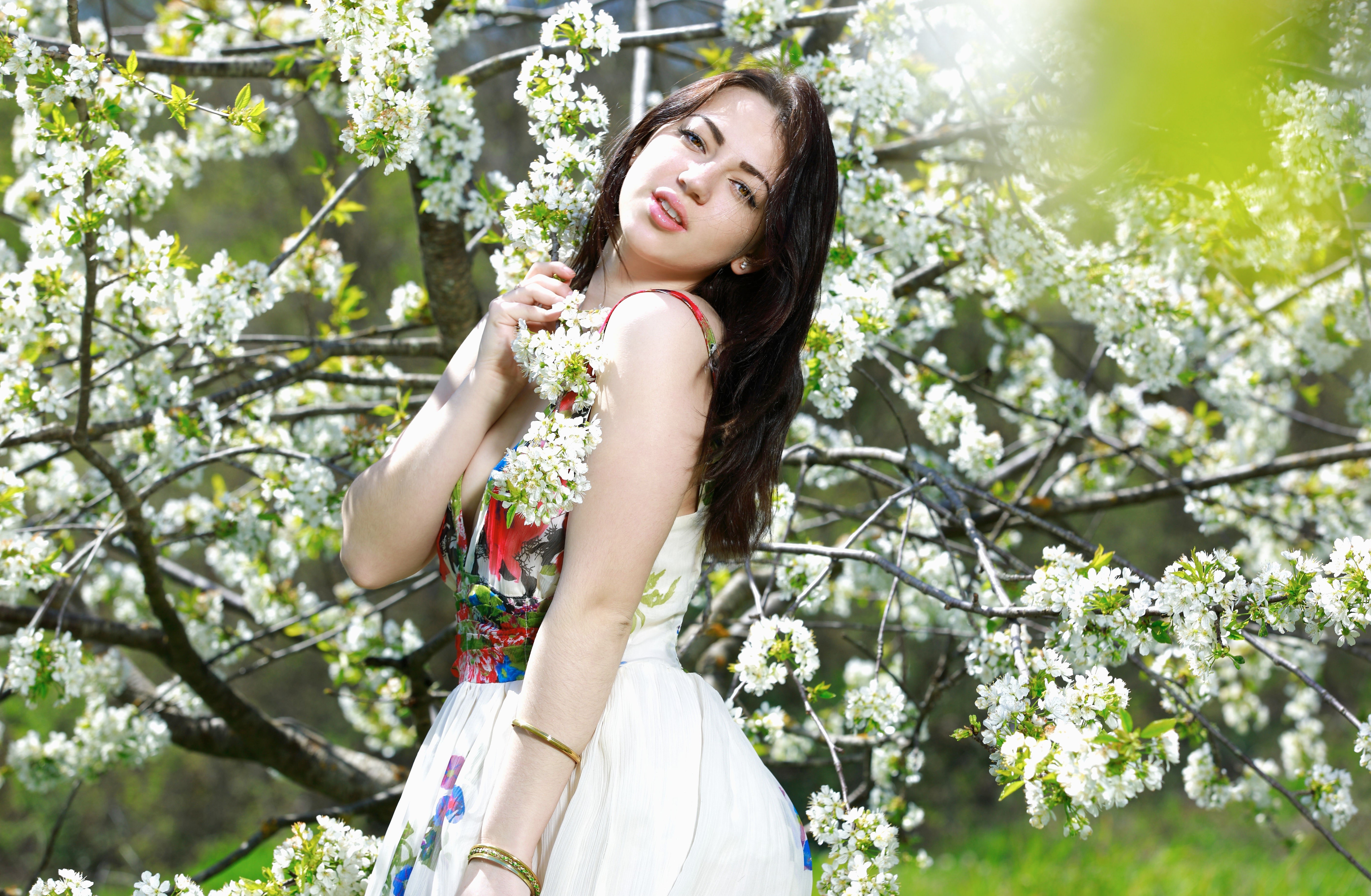Brunette girl in a dress among flowering trees HD Wallpaper
