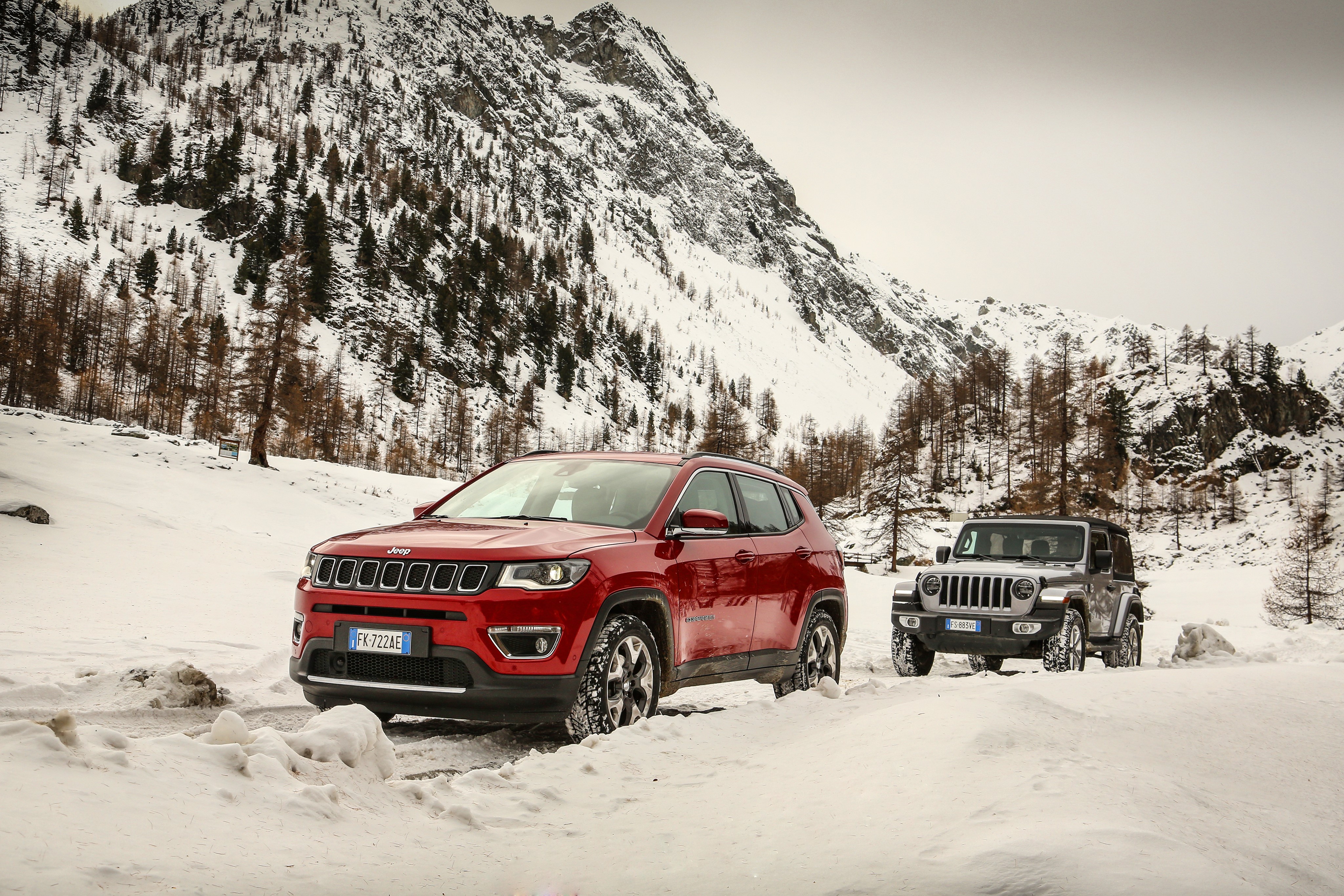 Two Jeep SUVs in Snowy Mountains HD Wallpaper