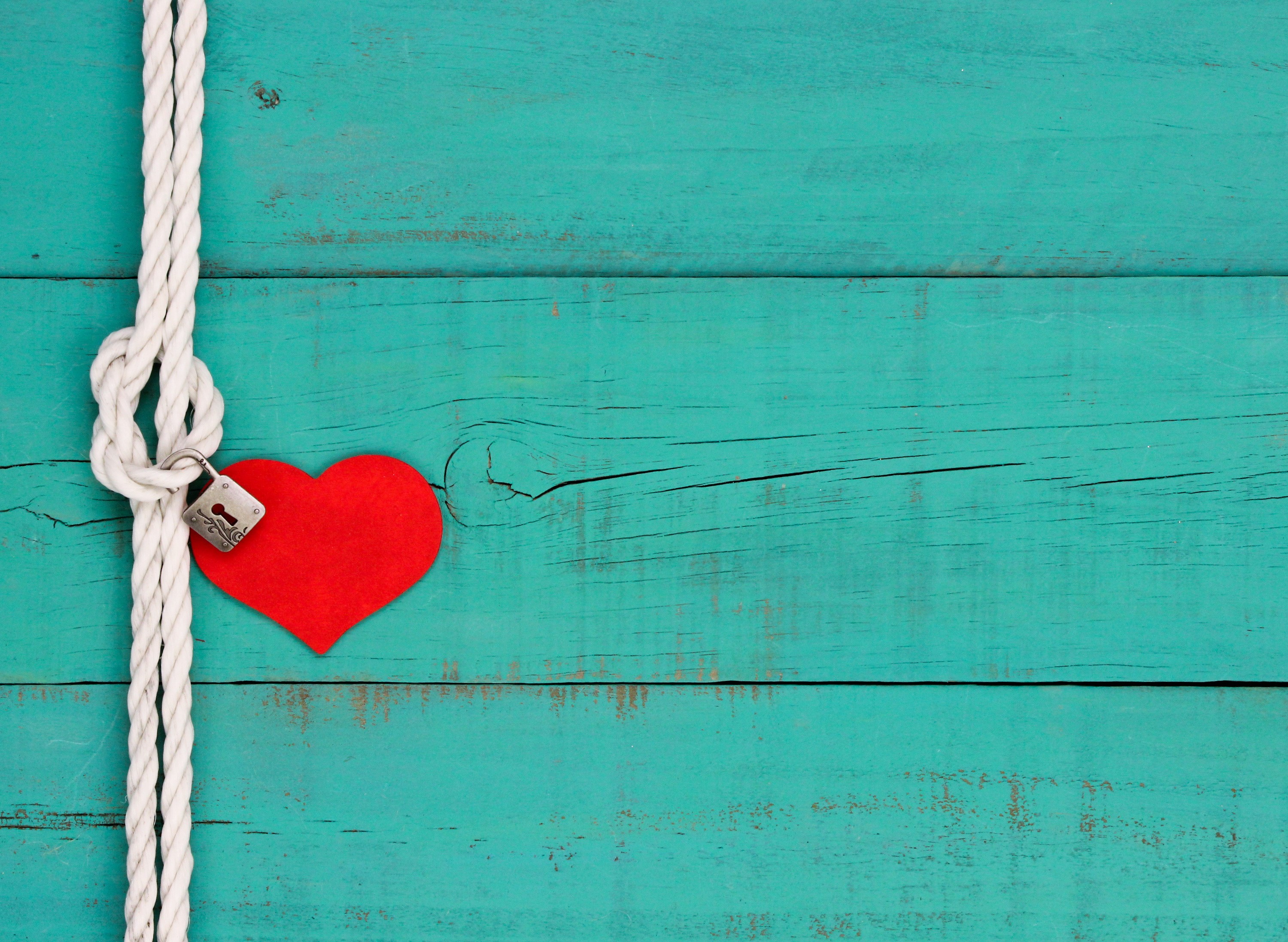 Red heart locked with a rope on a wooden background HD Wallpaper