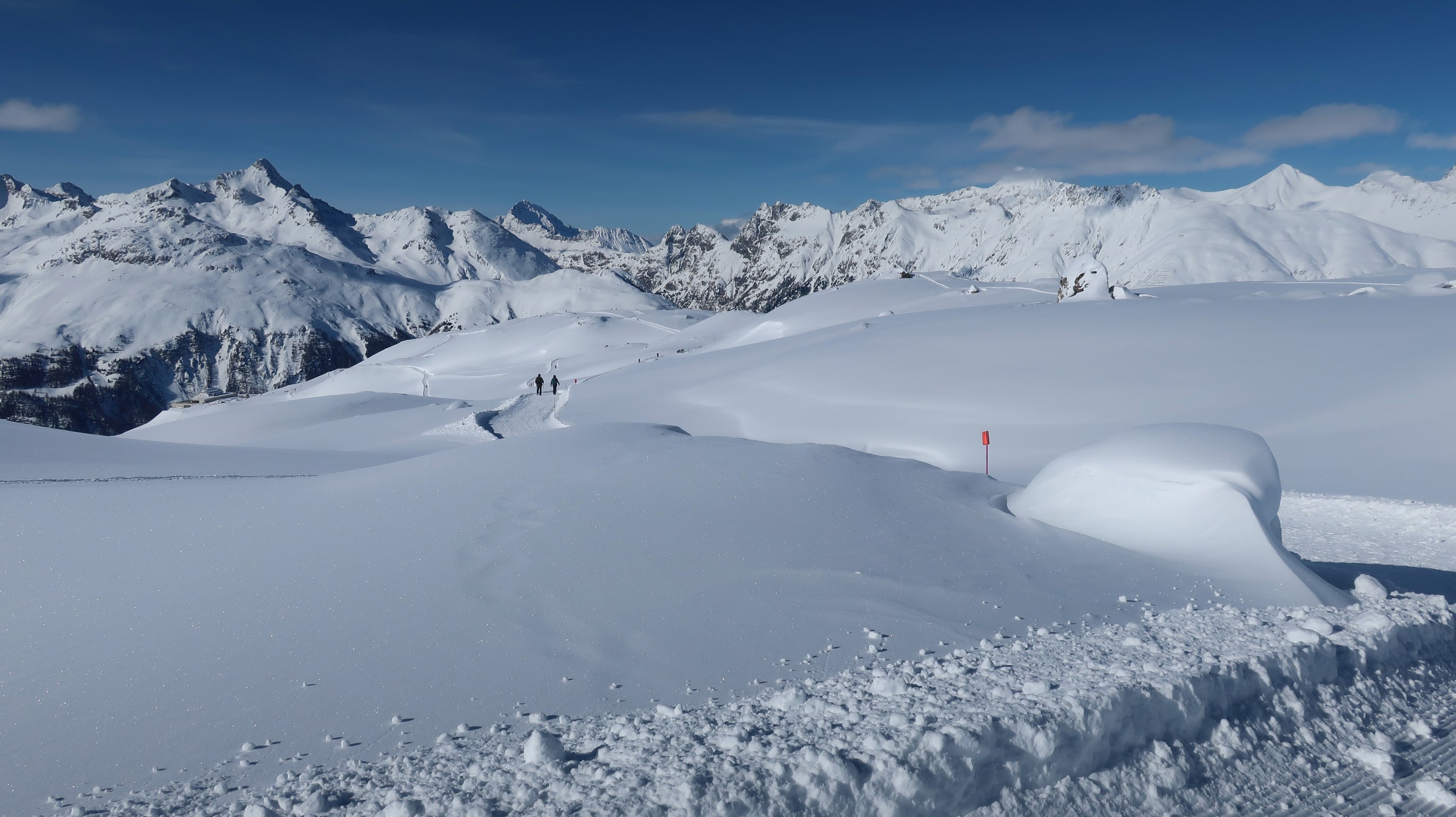 People hiking in snowy Alps near Pontresina, Switzerland HD Wallpaper