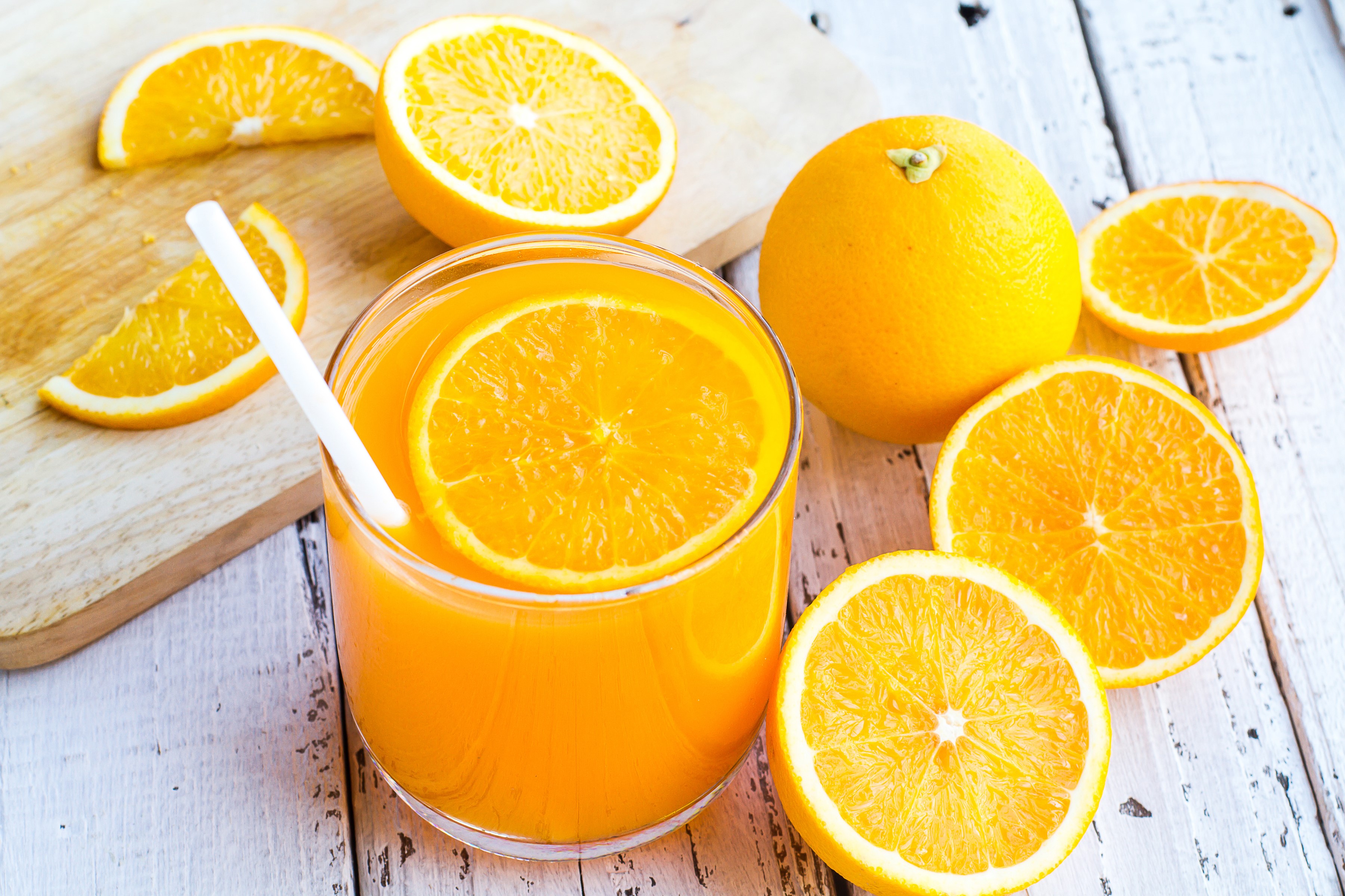 Orange juice in a glass with oranges HD Wallpaper