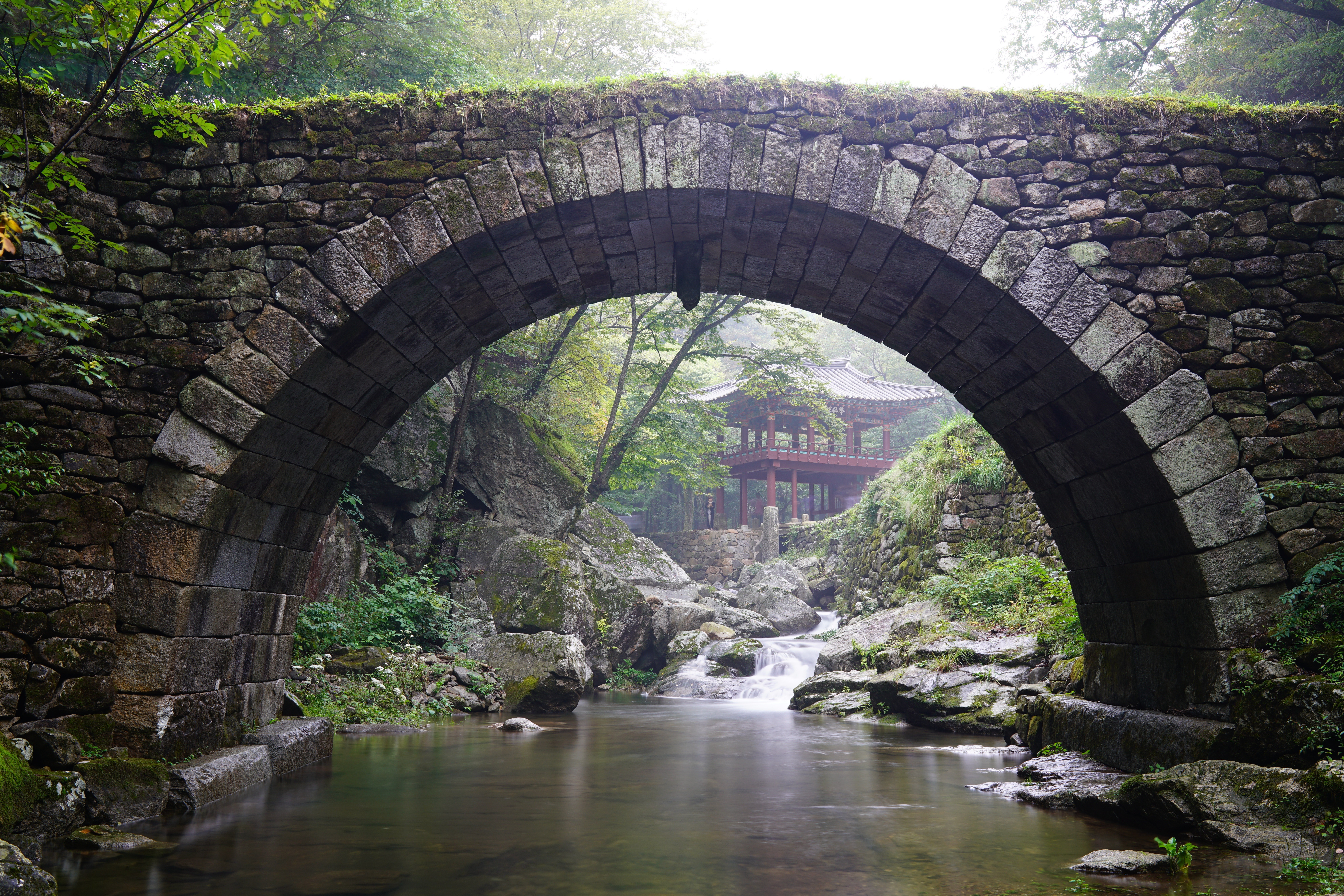 Stone Arch Bridge over Stream with Korean Pavilion HD Wallpaper