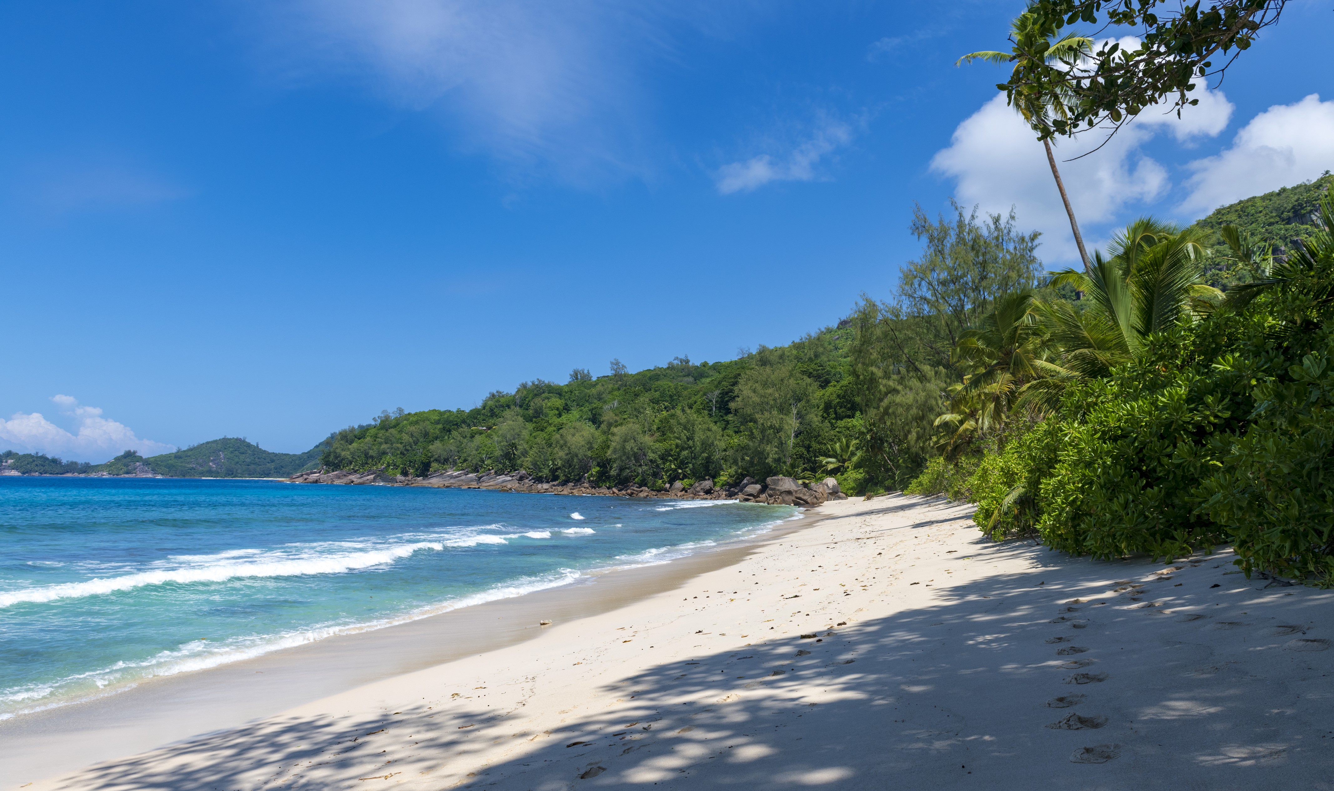 4K Seychelles Anse Takamaka Beach with Waves and Lush Vegetation HD Wallpaper
