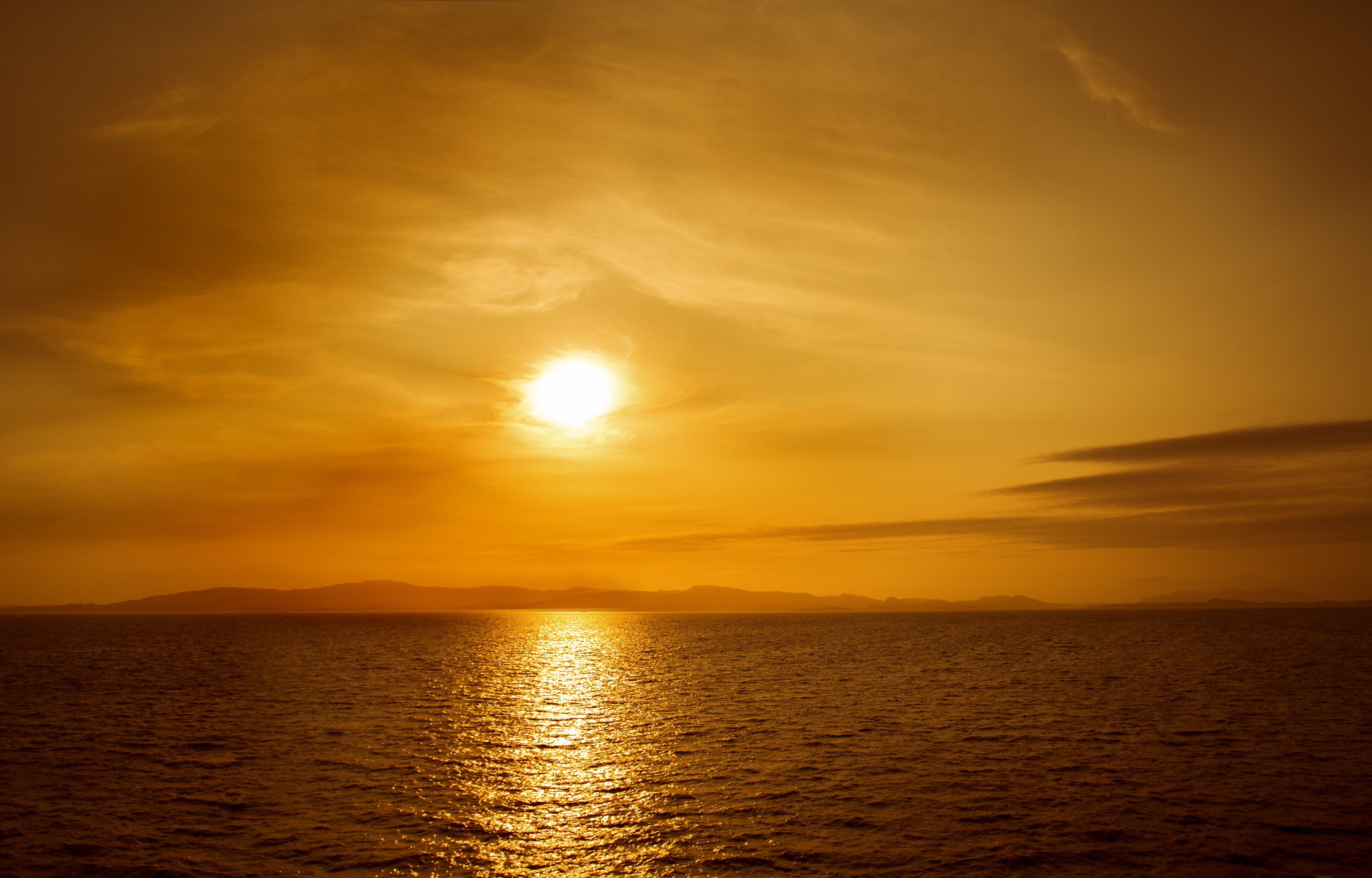 Sunset over the sea with mountains HD Wallpaper