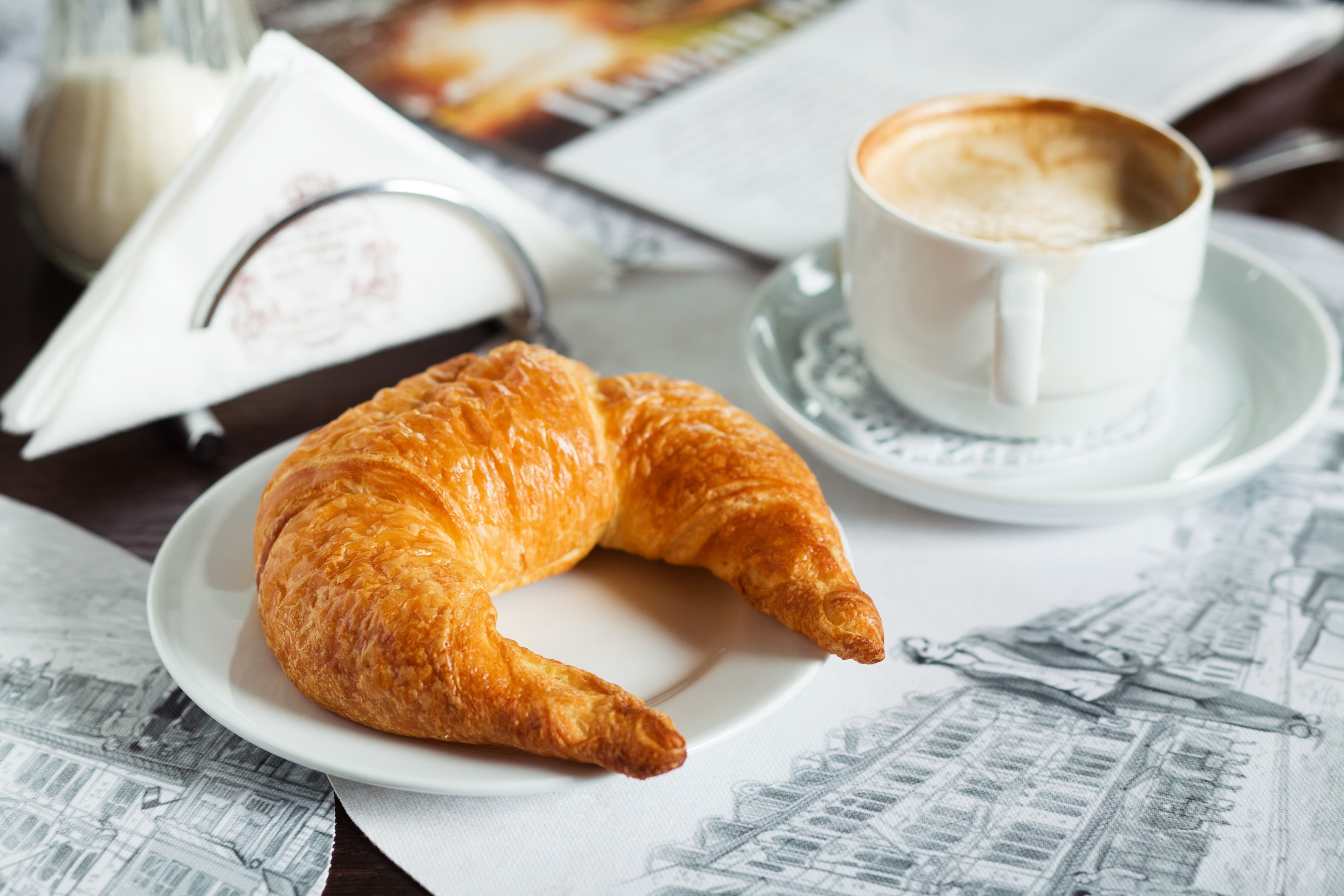Croissant and Cappuccino on a Table HD Wallpaper