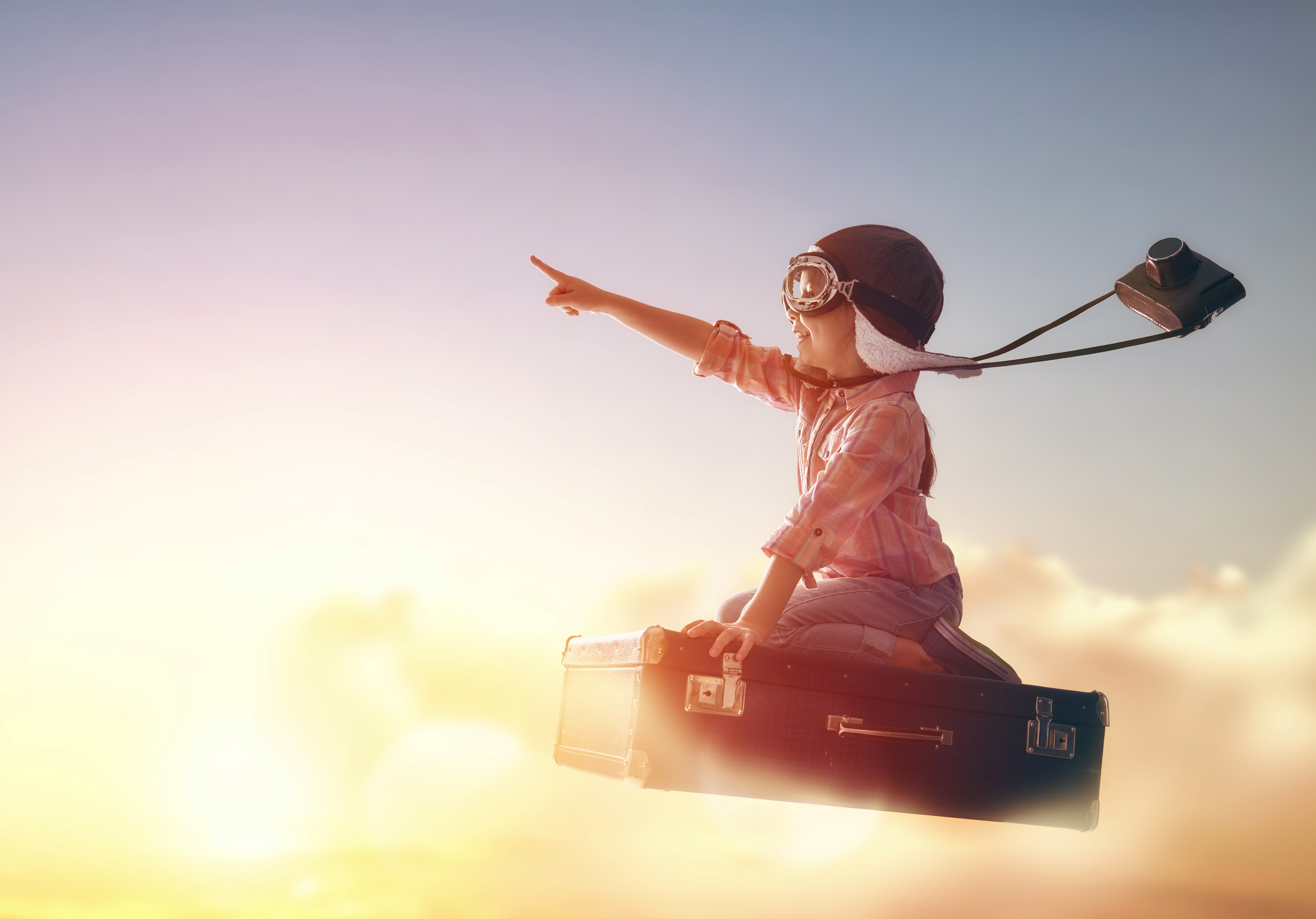 Girl in Helmet Flying with Suitcase and Camera HD Wallpaper