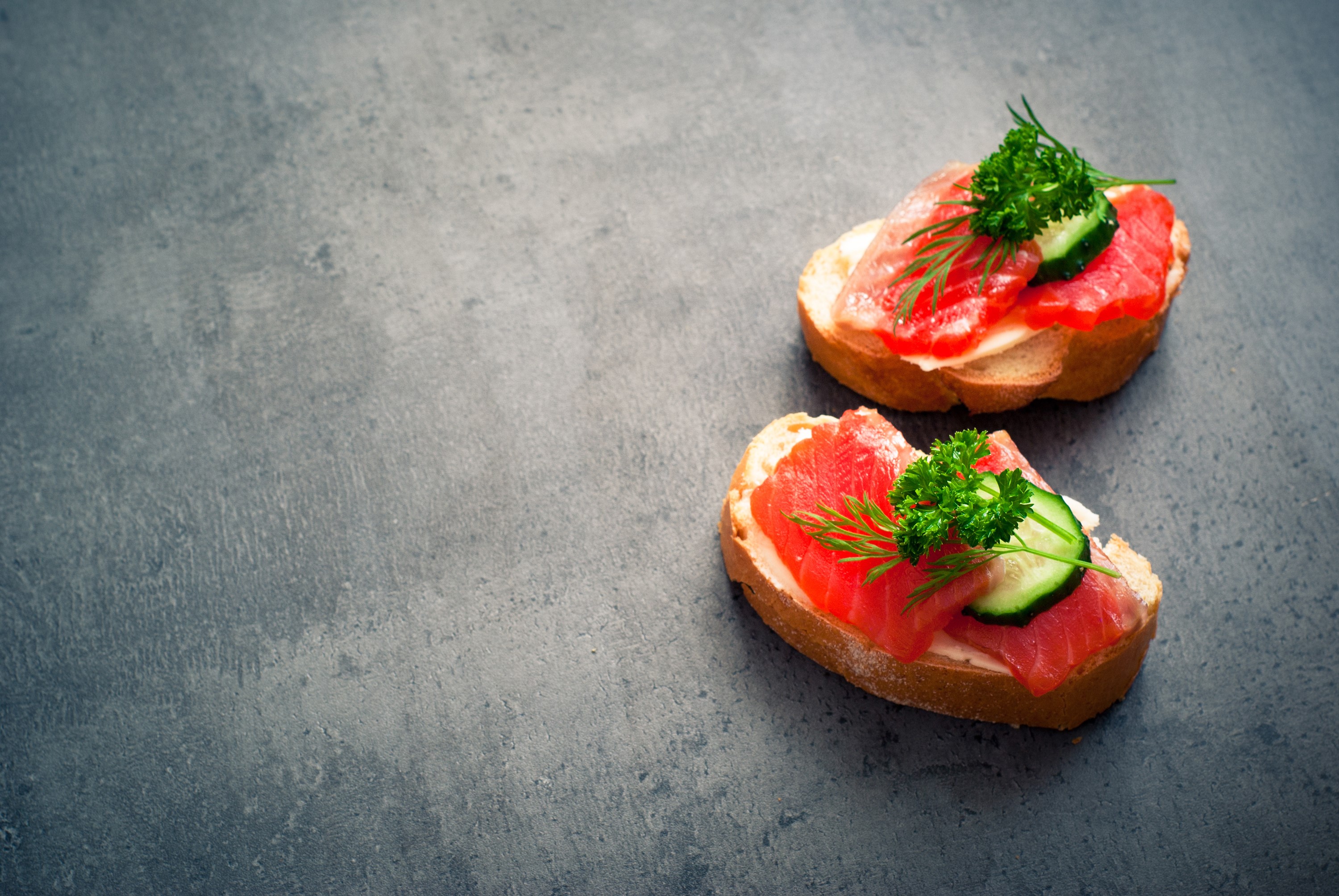 Two open-faced sandwiches with salmon and cucumber HD Wallpaper