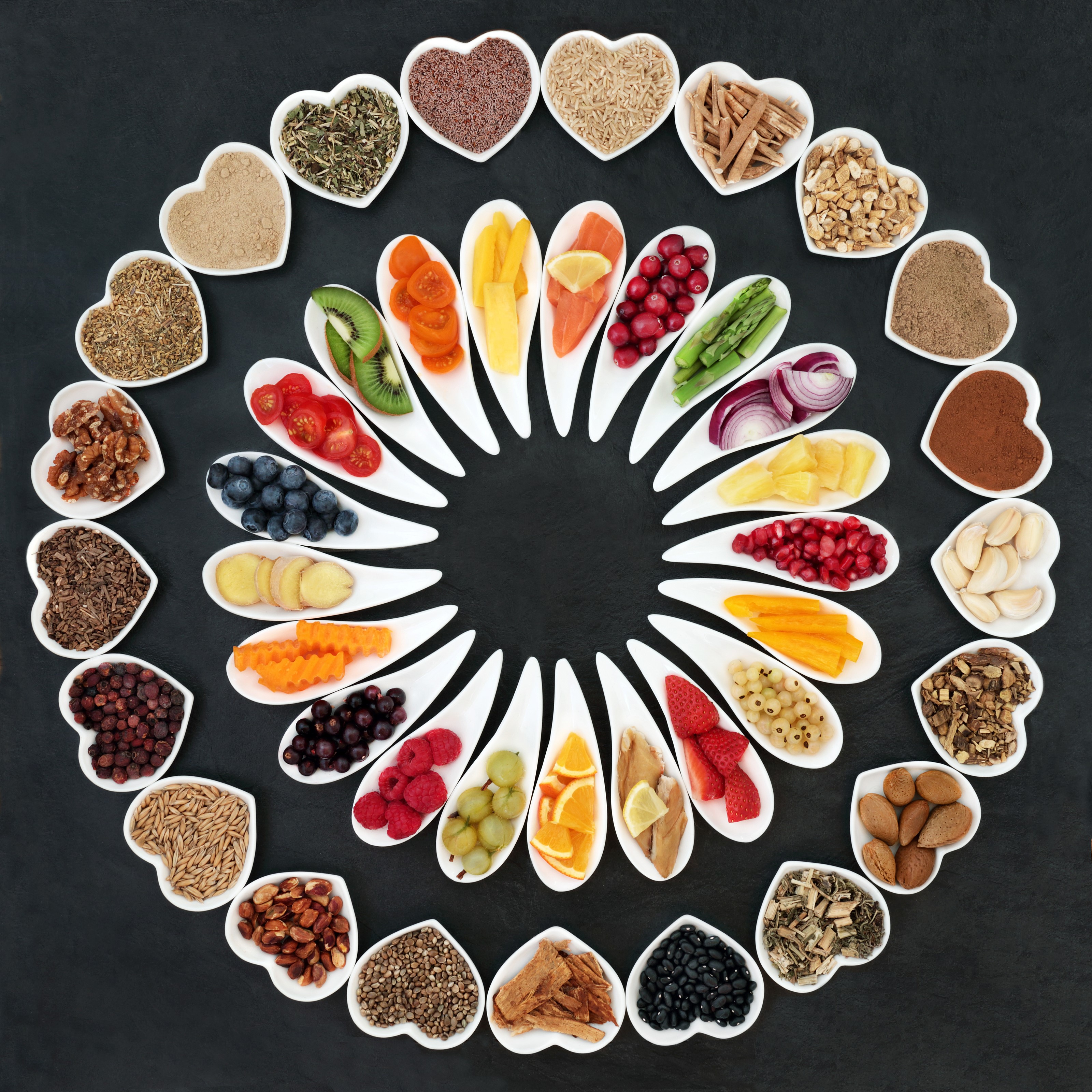 Heart-shaped bowls of healthy foods arranged in a circle HD Wallpaper