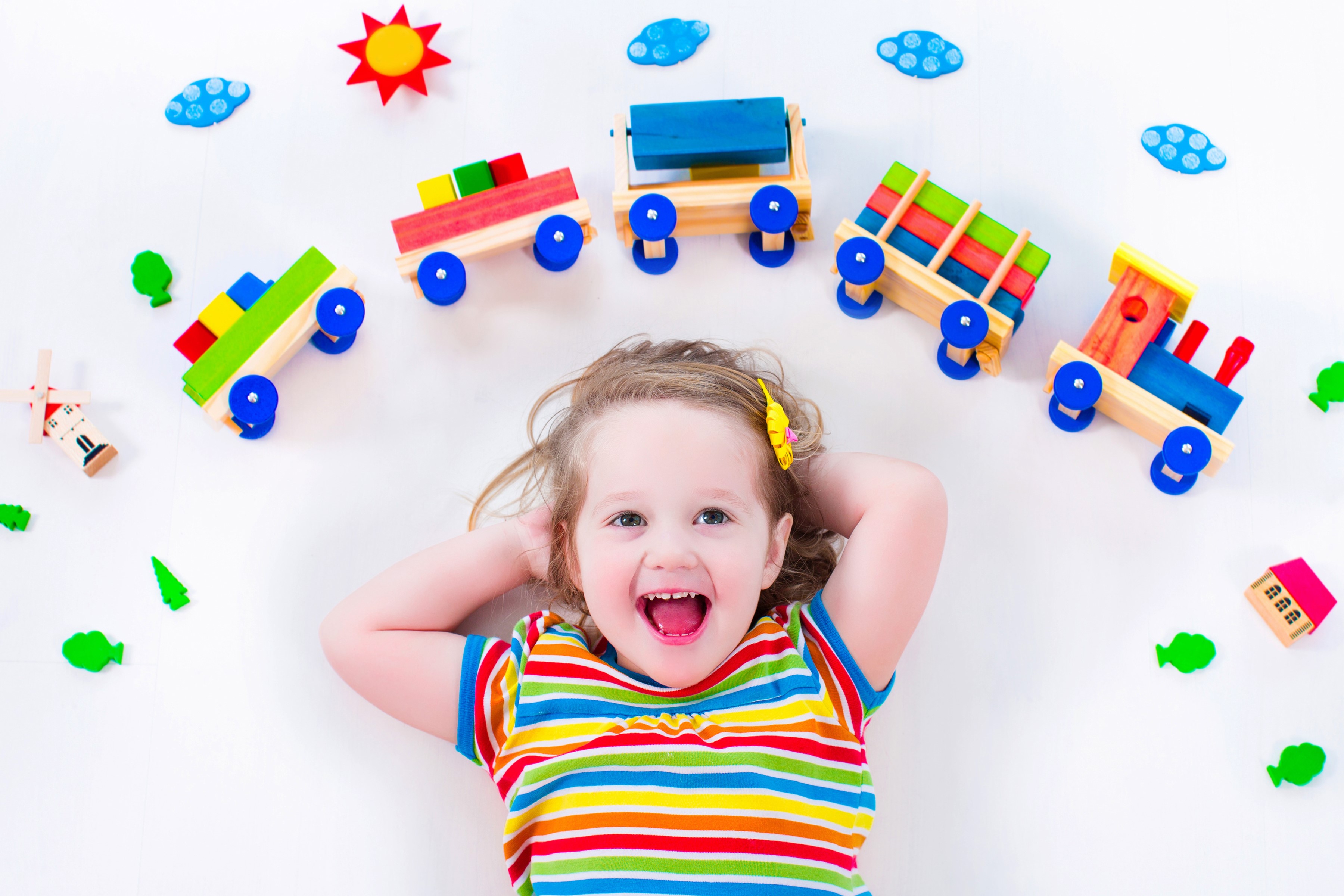 Little girl with toy train on white background HD Wallpaper
