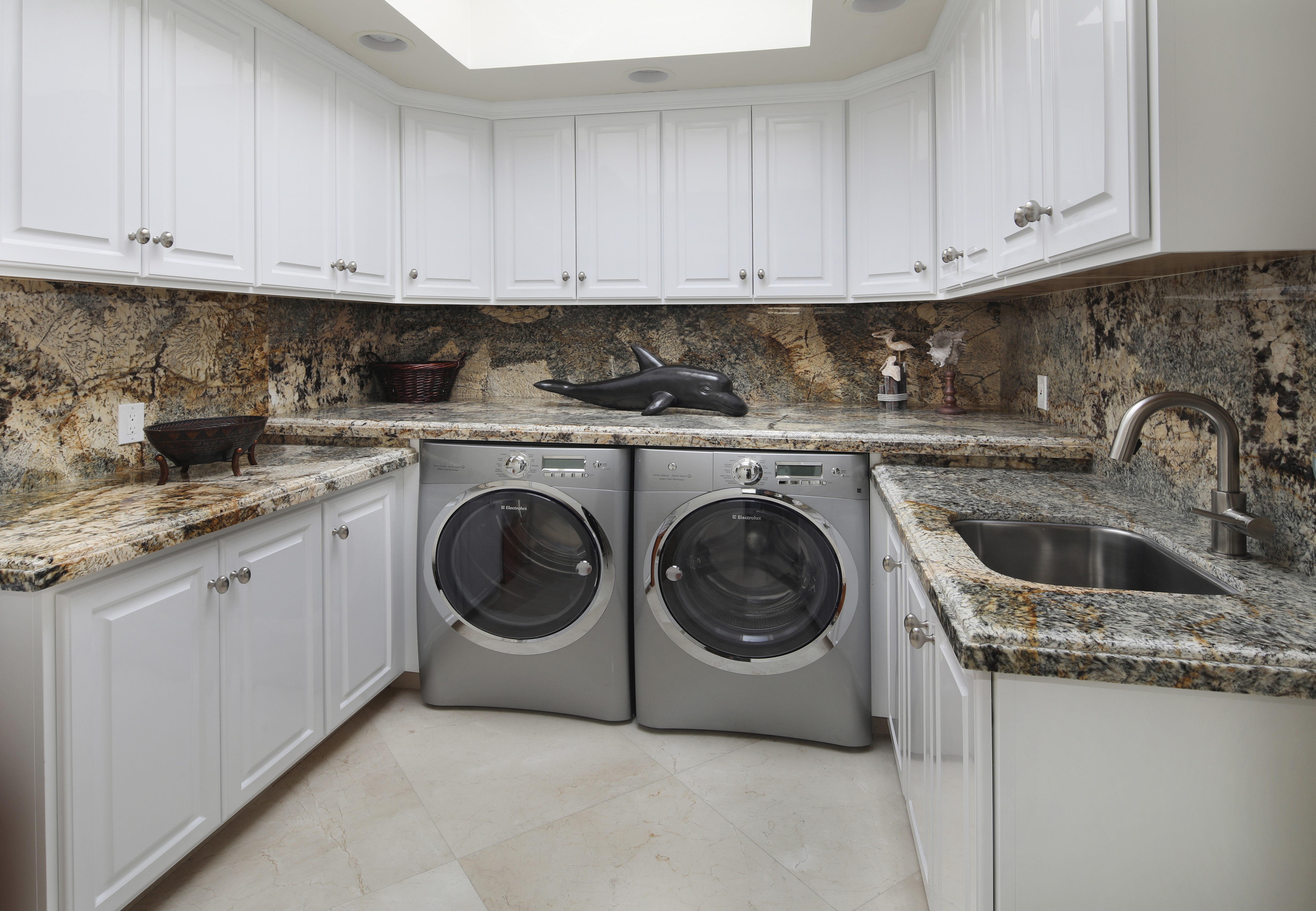 Laundry room with white cabinets and granite countertops HD Wallpaper