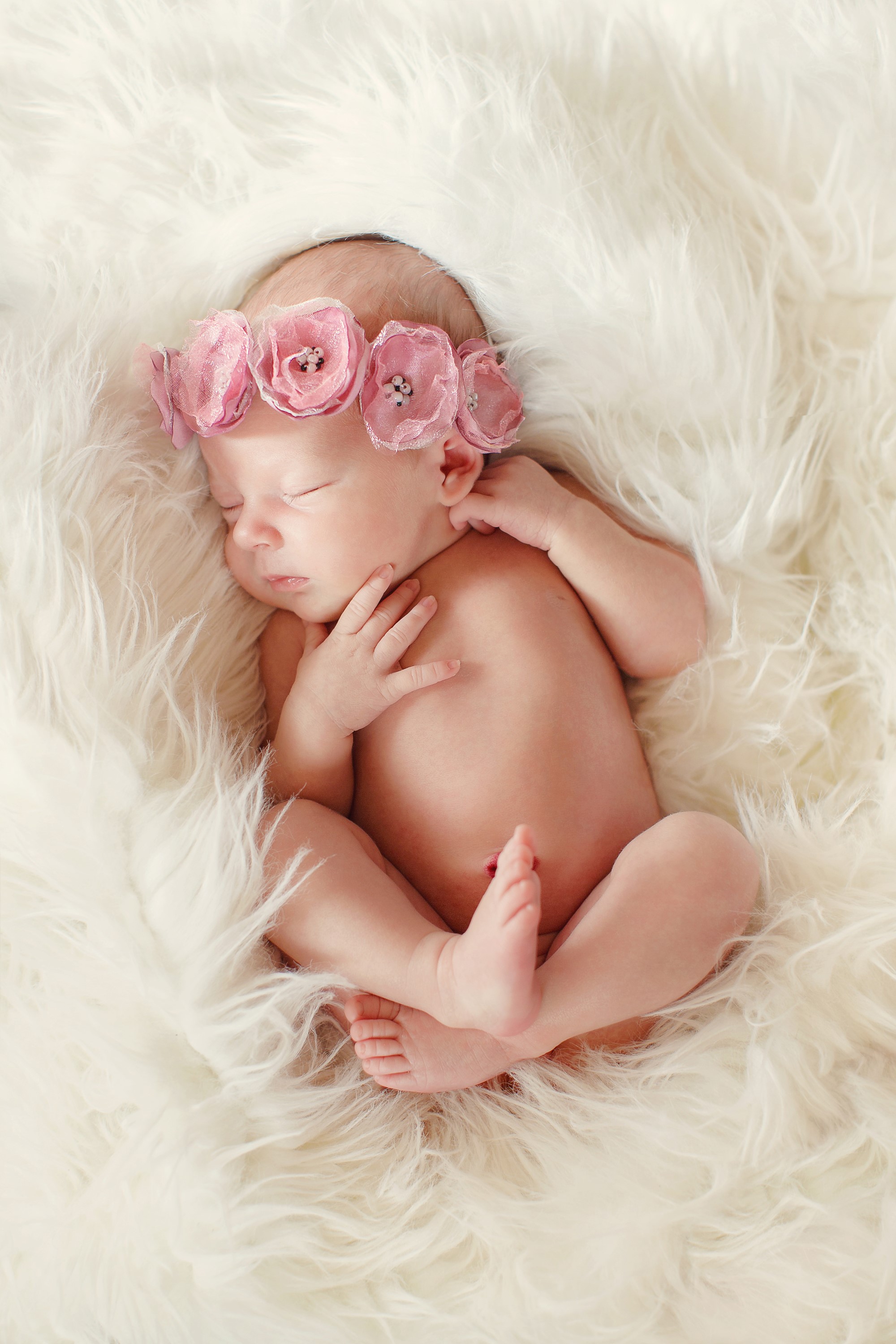 Newborn baby sleeping on white fur with flower crown HD Phone Wallpaper